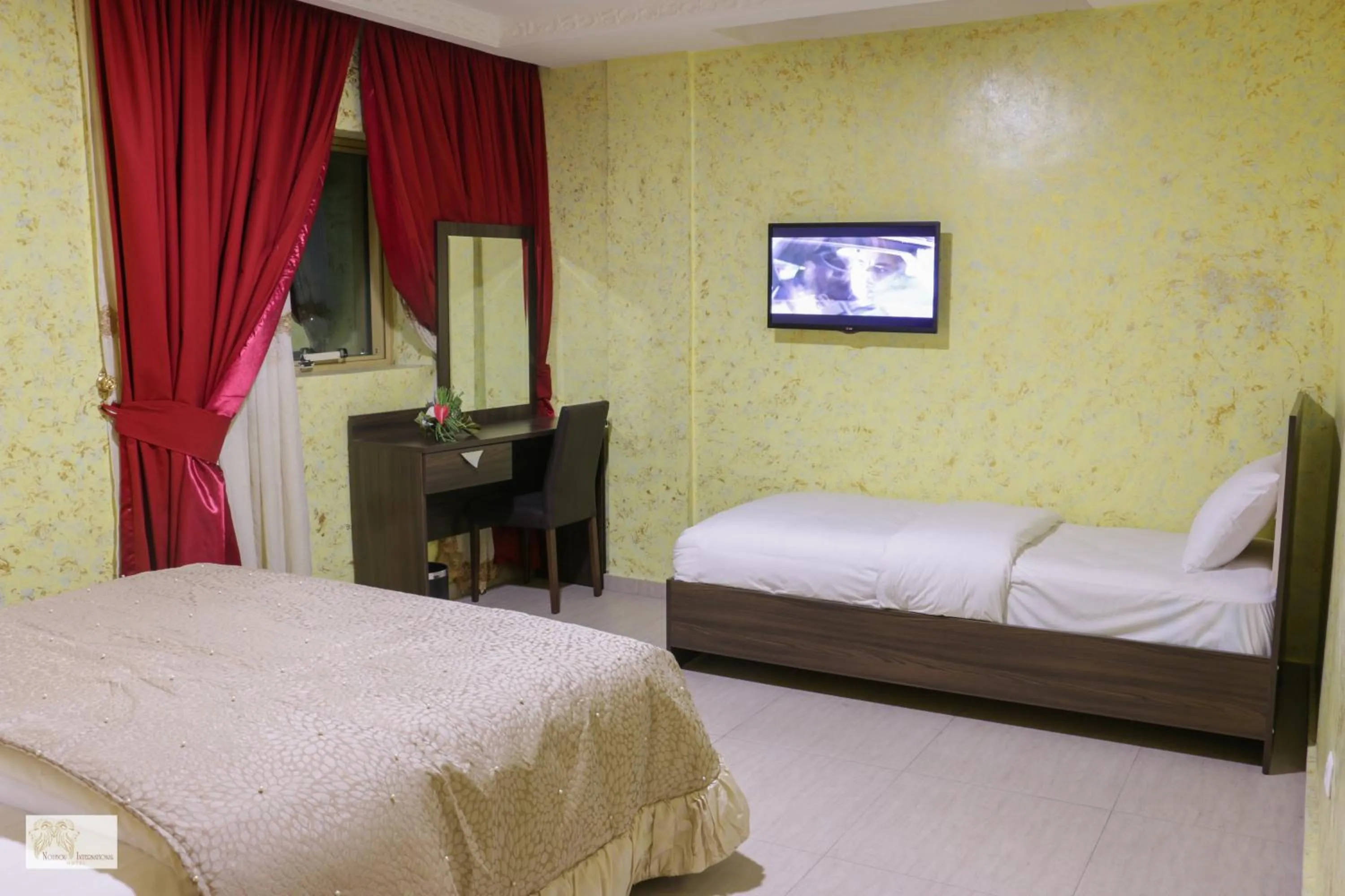 Bed in Noubou International Hotel