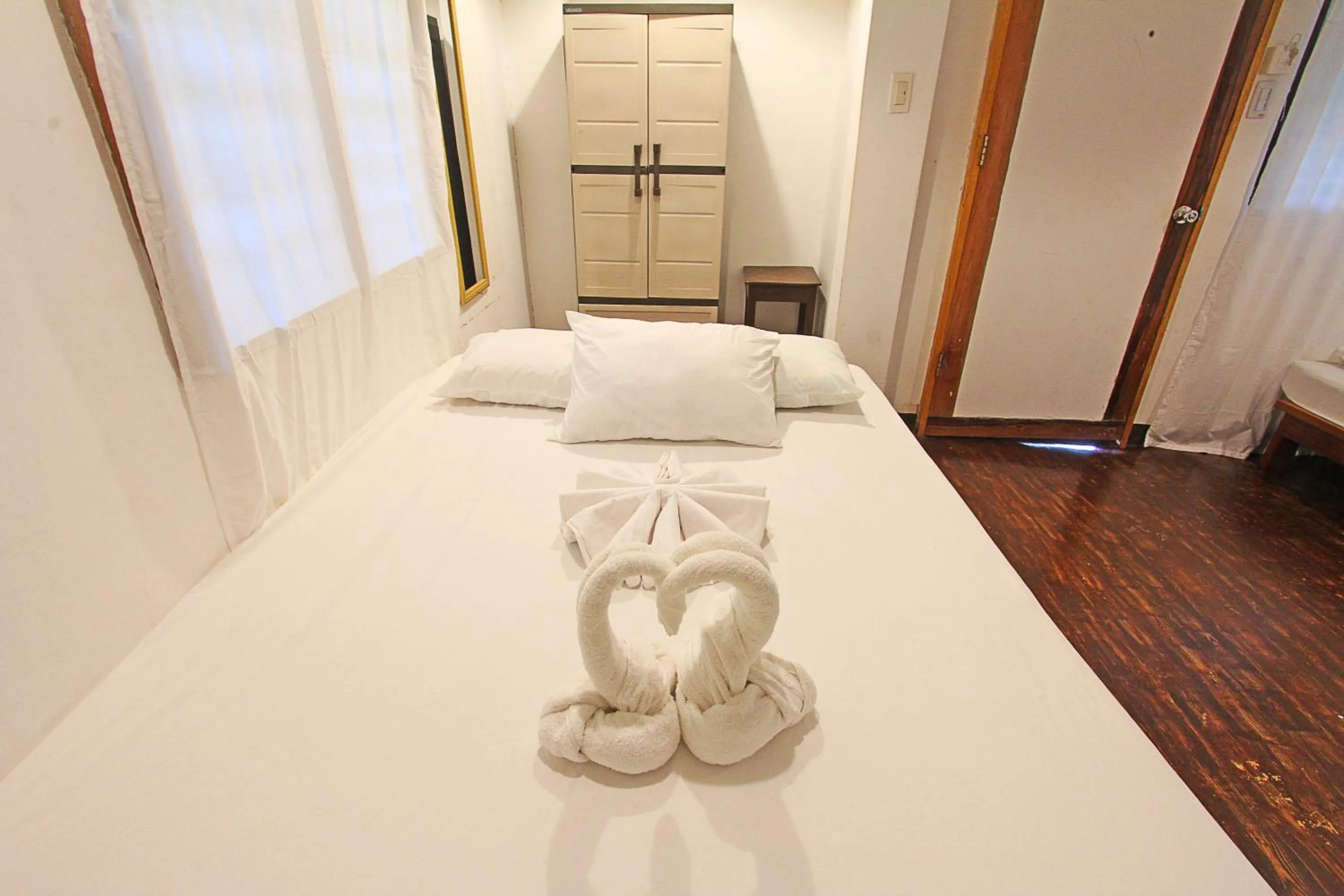 Bed in Patrick's on the Beach Resort