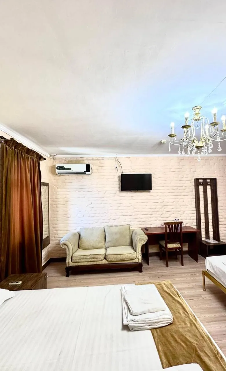 Communal lounge/ TV room, Bed in Star Hotel