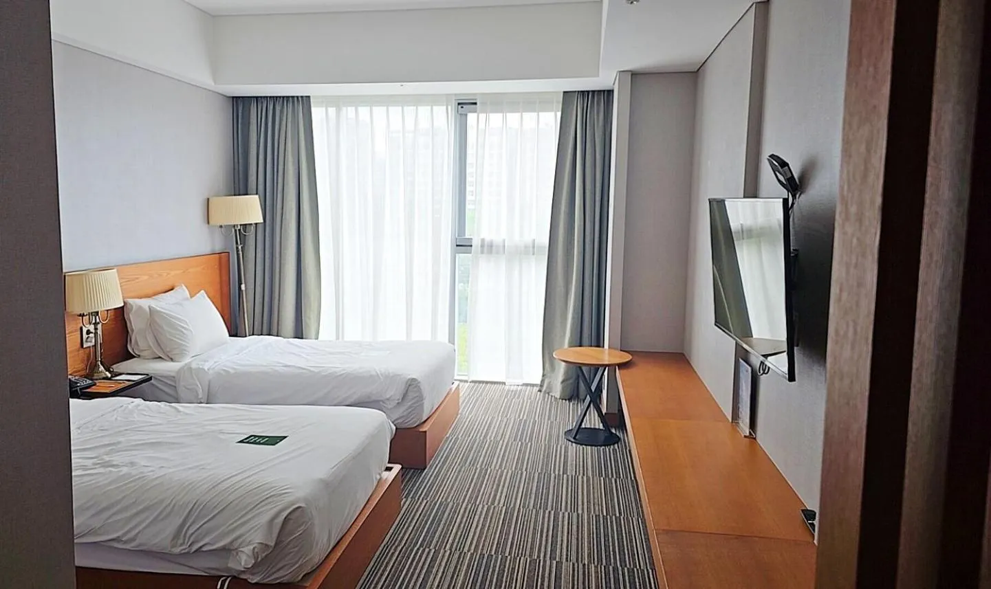 Bed in Golden Tulip Incheon Airport Hotel