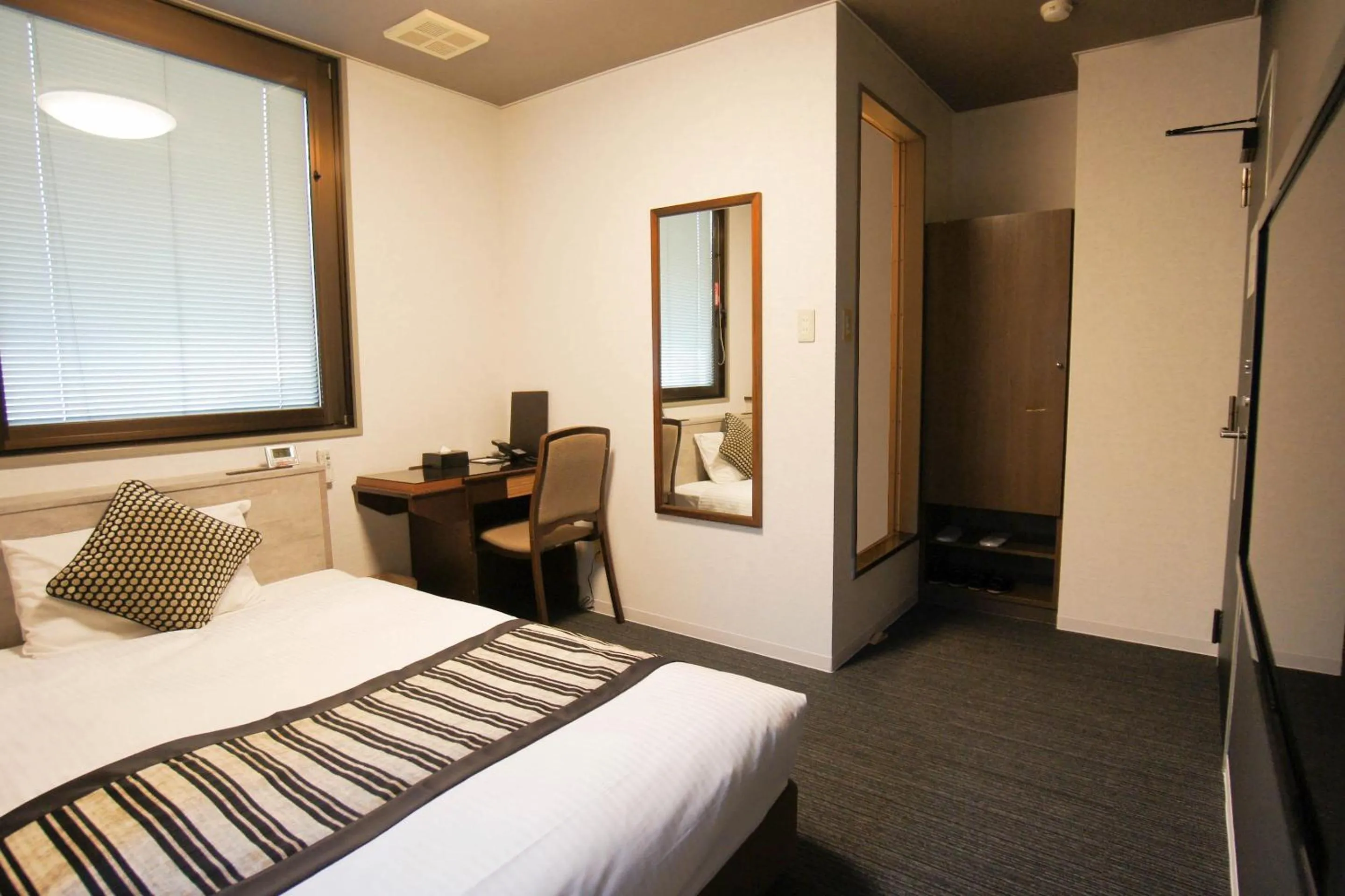 Bed in Hotel AreaOne Nobeoka