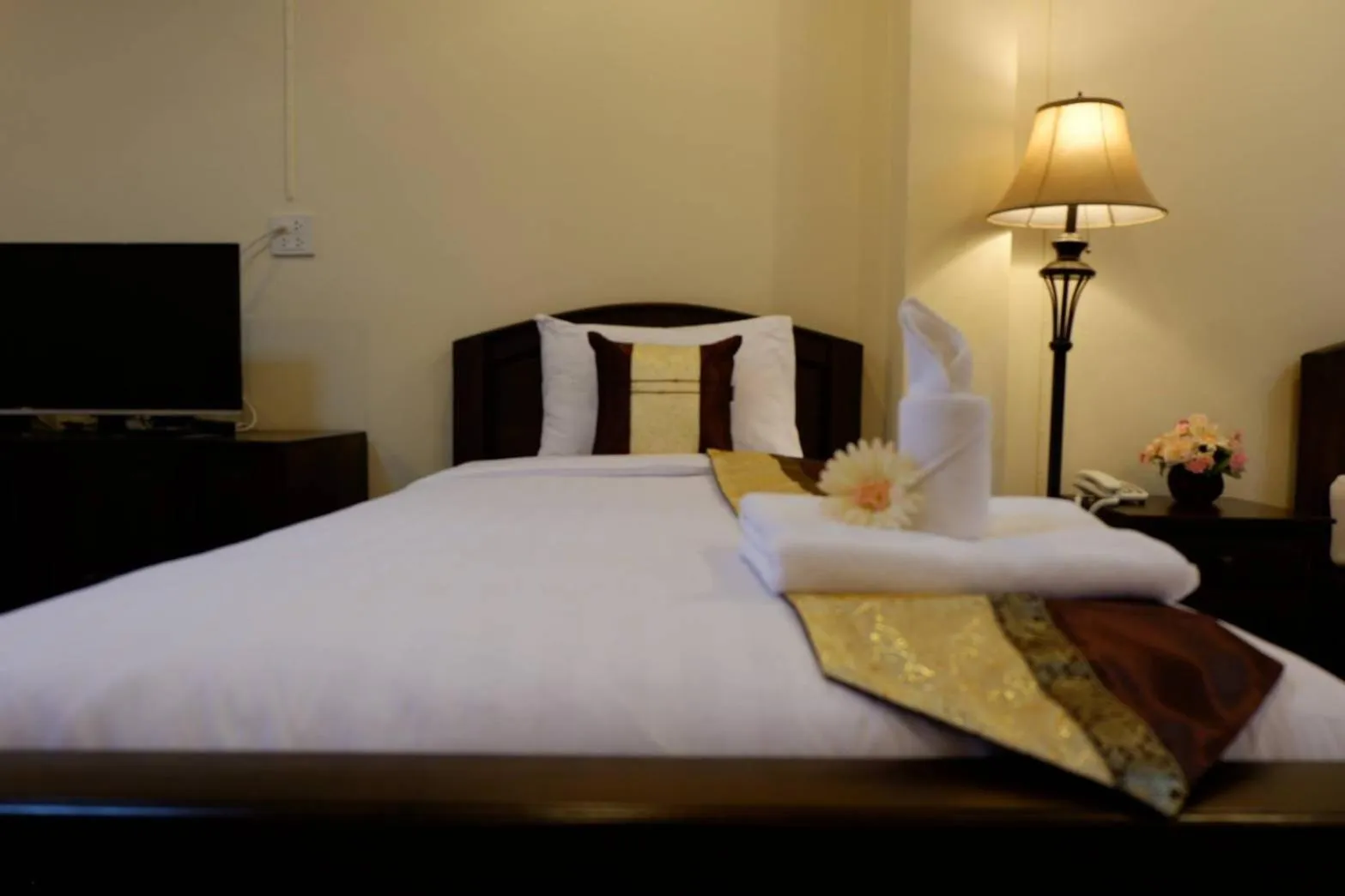 Bed in NanBaanKhun Hotel