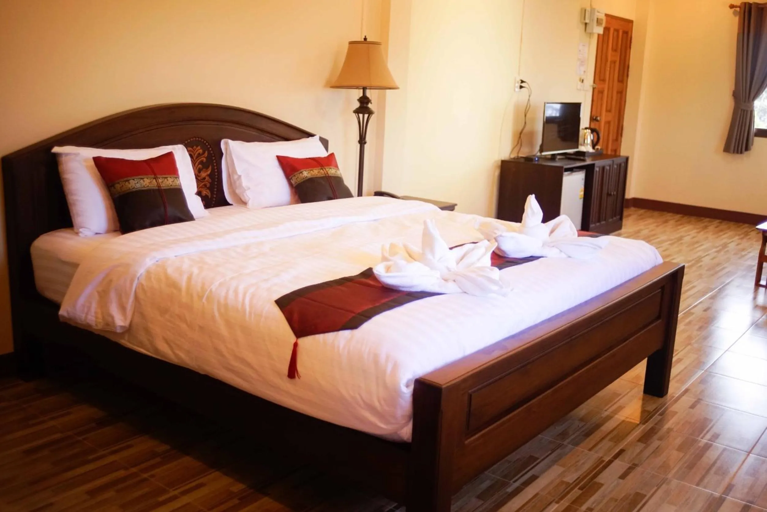 Bed in NanBaanKhun Hotel