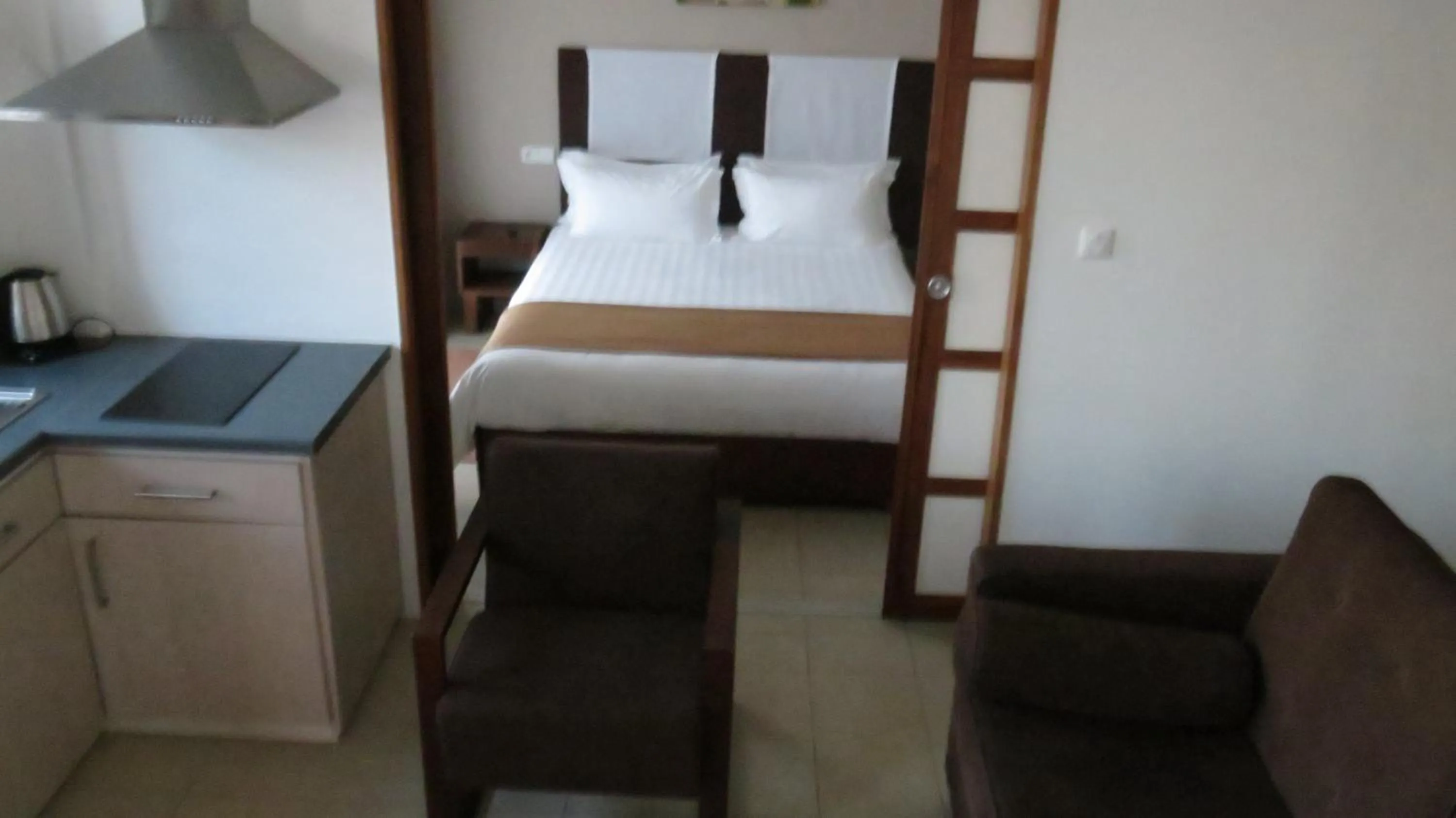 Kitchen or kitchenette, Bed in Plumeria Hotel