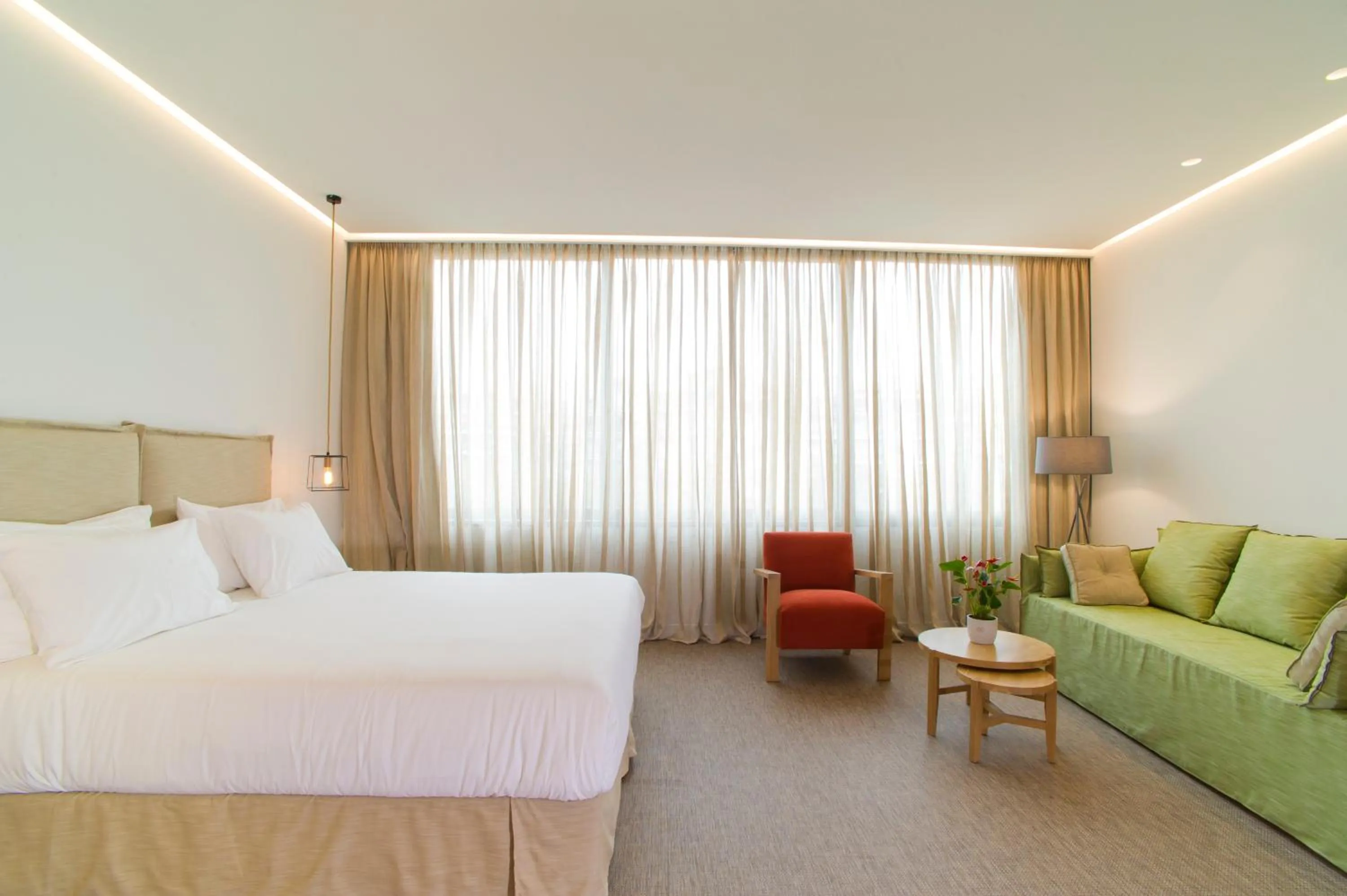 Seating area, Bed in NLH FIX | Neighborhood Lifestyle Hotels