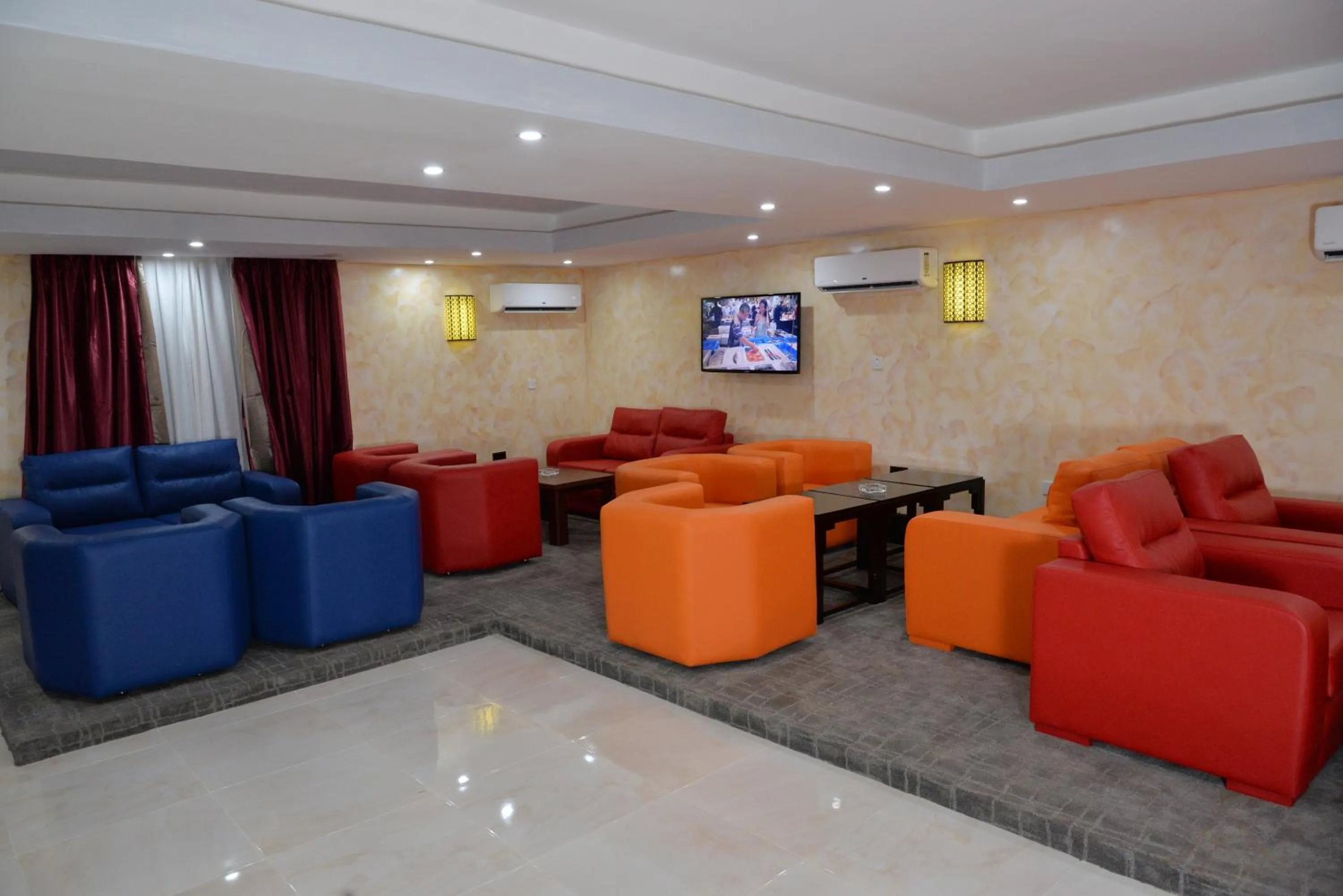 Communal lounge/ TV room in Grand Pela Hotel & Suites