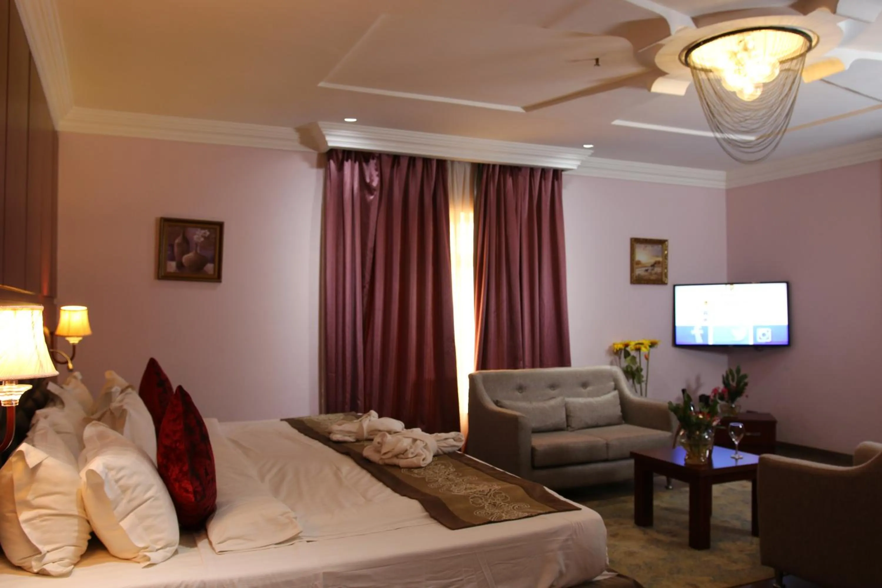 Bed in Grand Pela Hotel & Suites