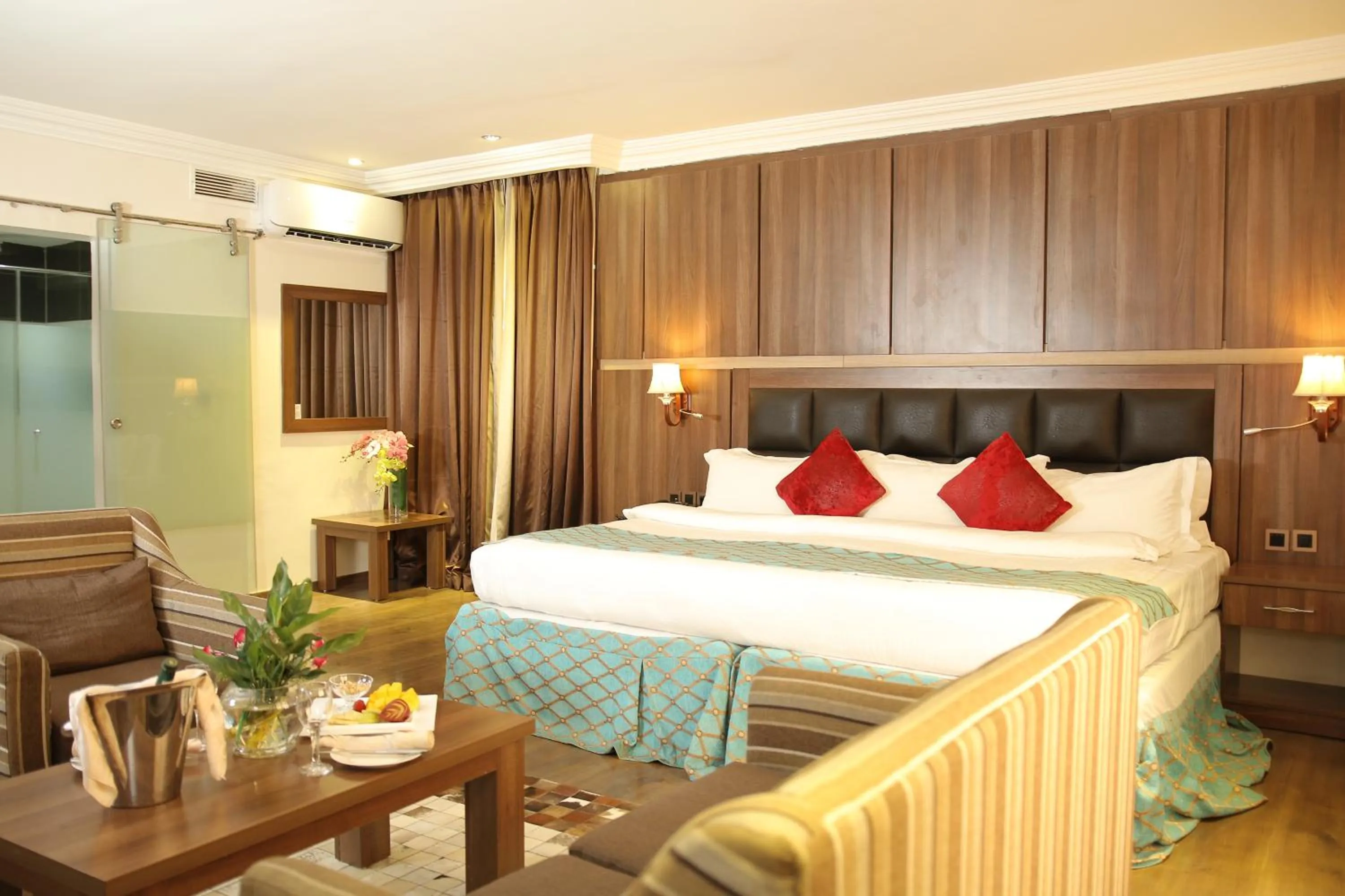 Bed in Grand Pela Hotel & Suites