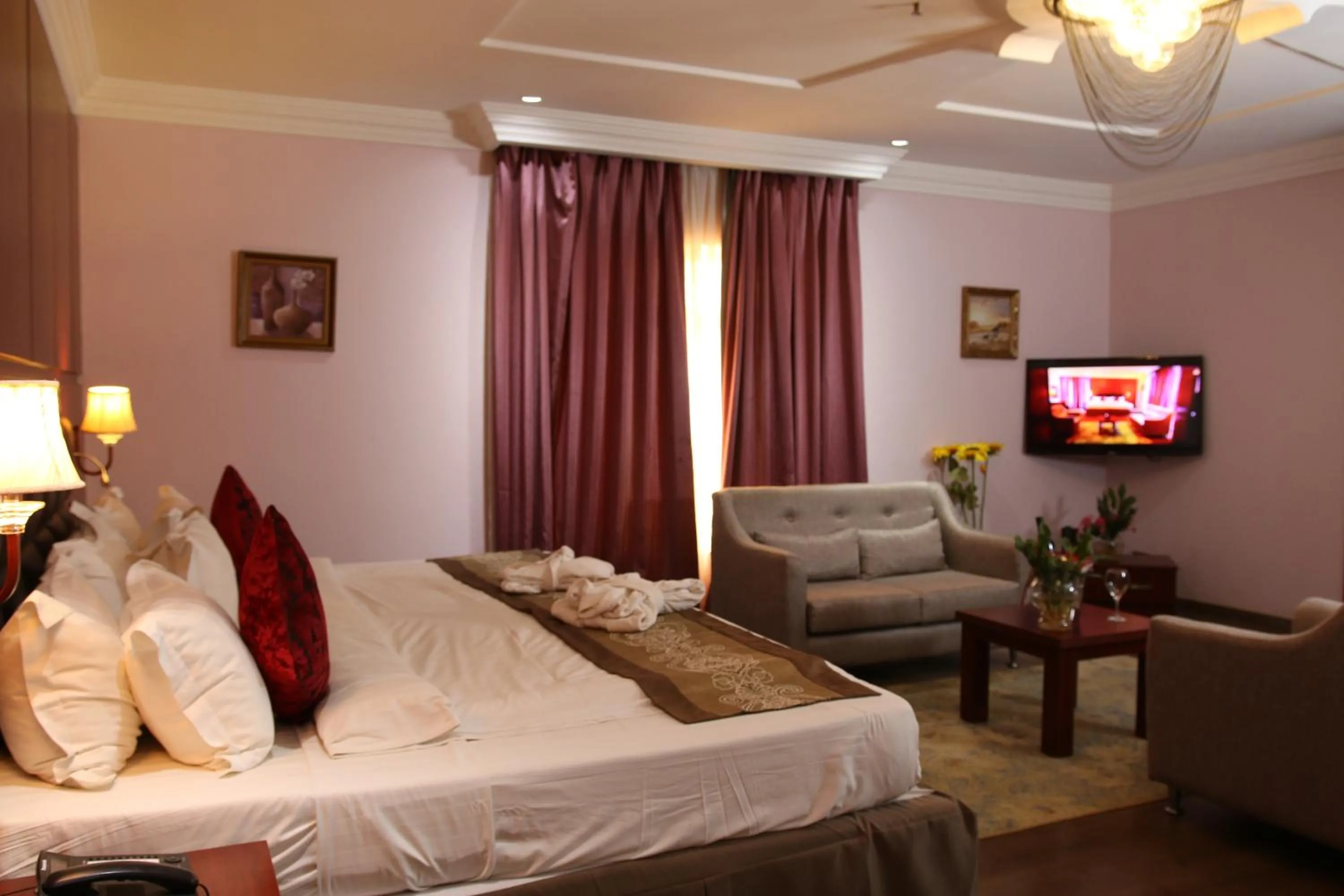 Bed in Grand Pela Hotel & Suites