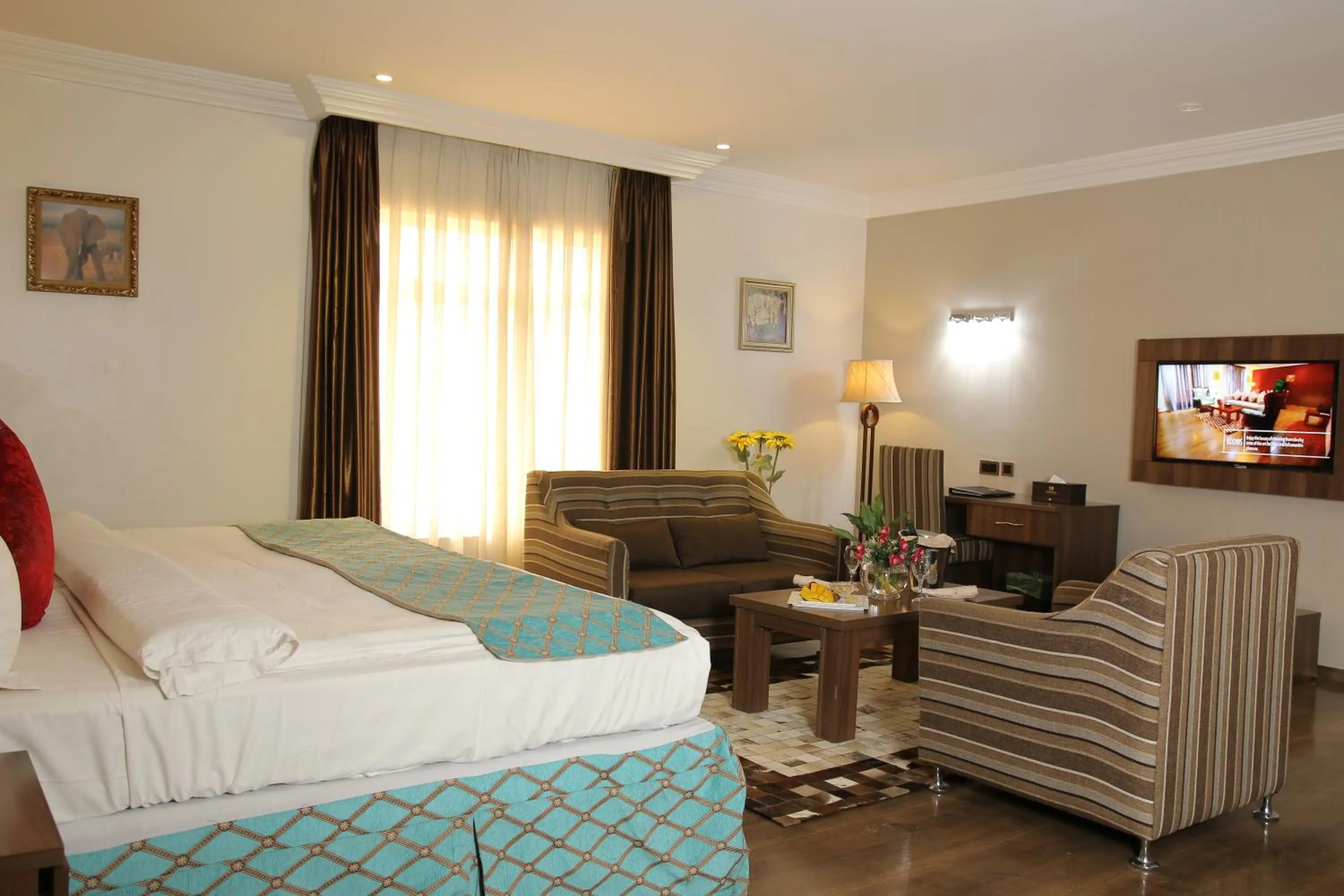 Bed in Grand Pela Hotel & Suites