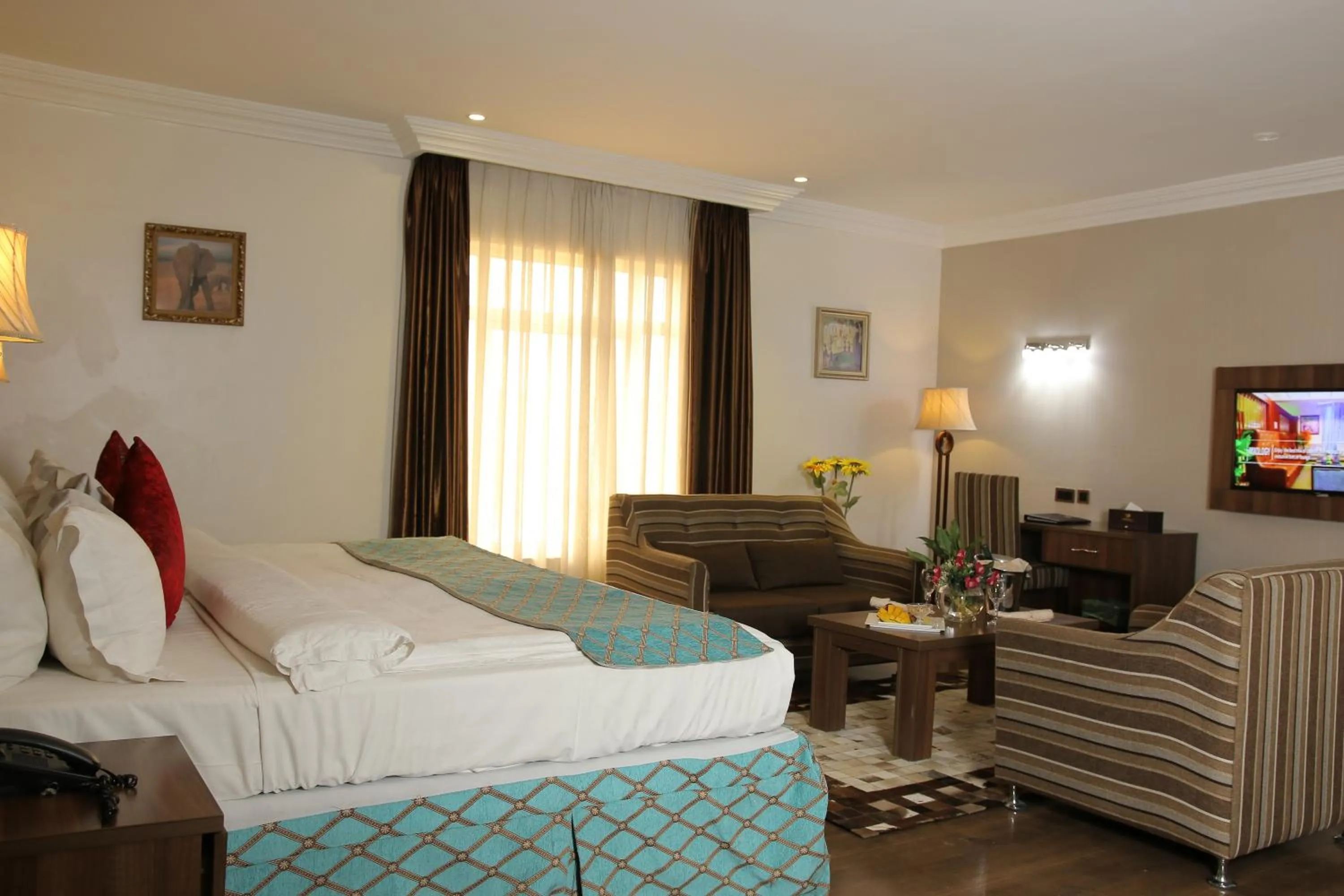 Bed in Grand Pela Hotel & Suites