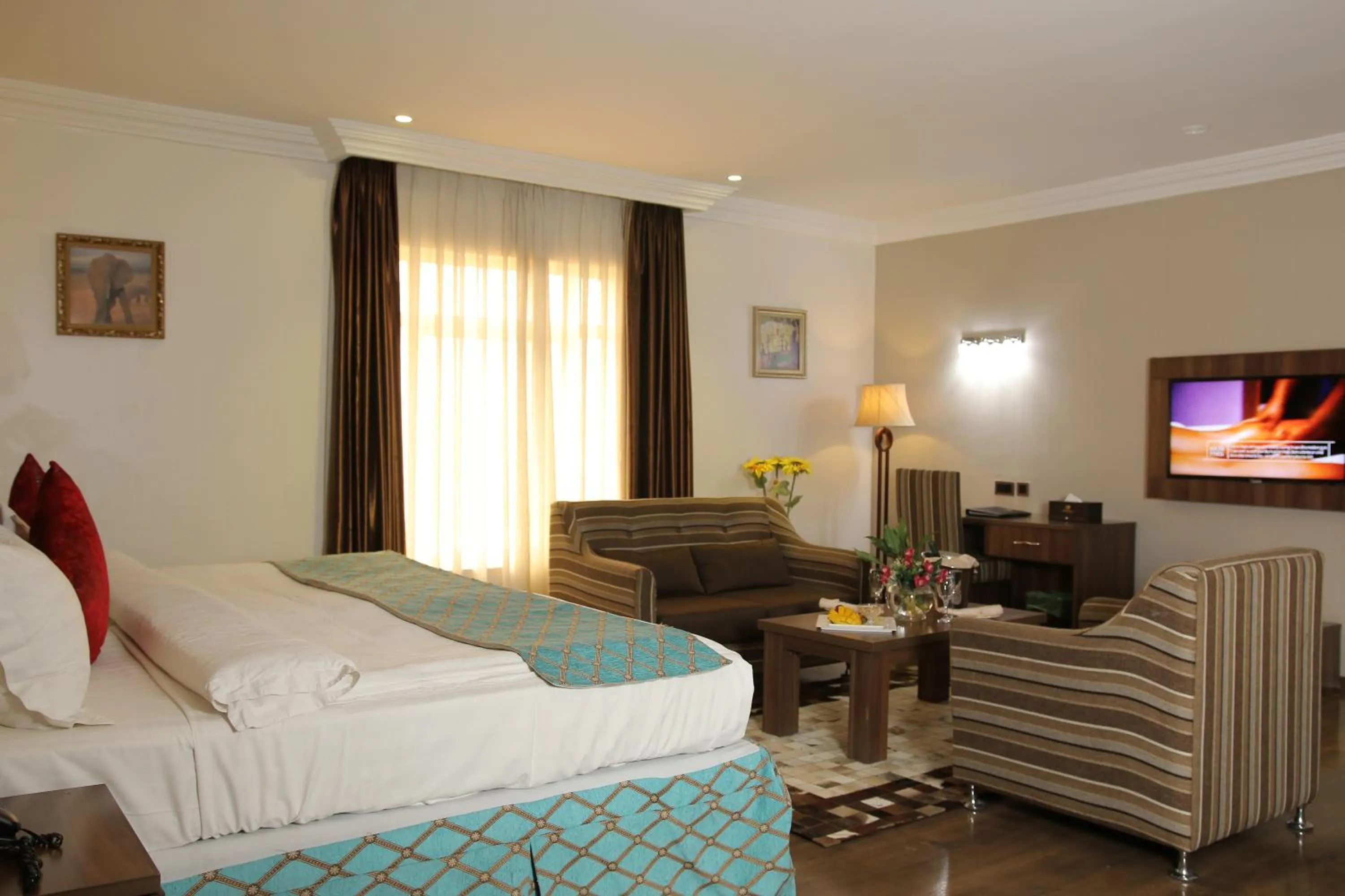 Bed in Grand Pela Hotel & Suites