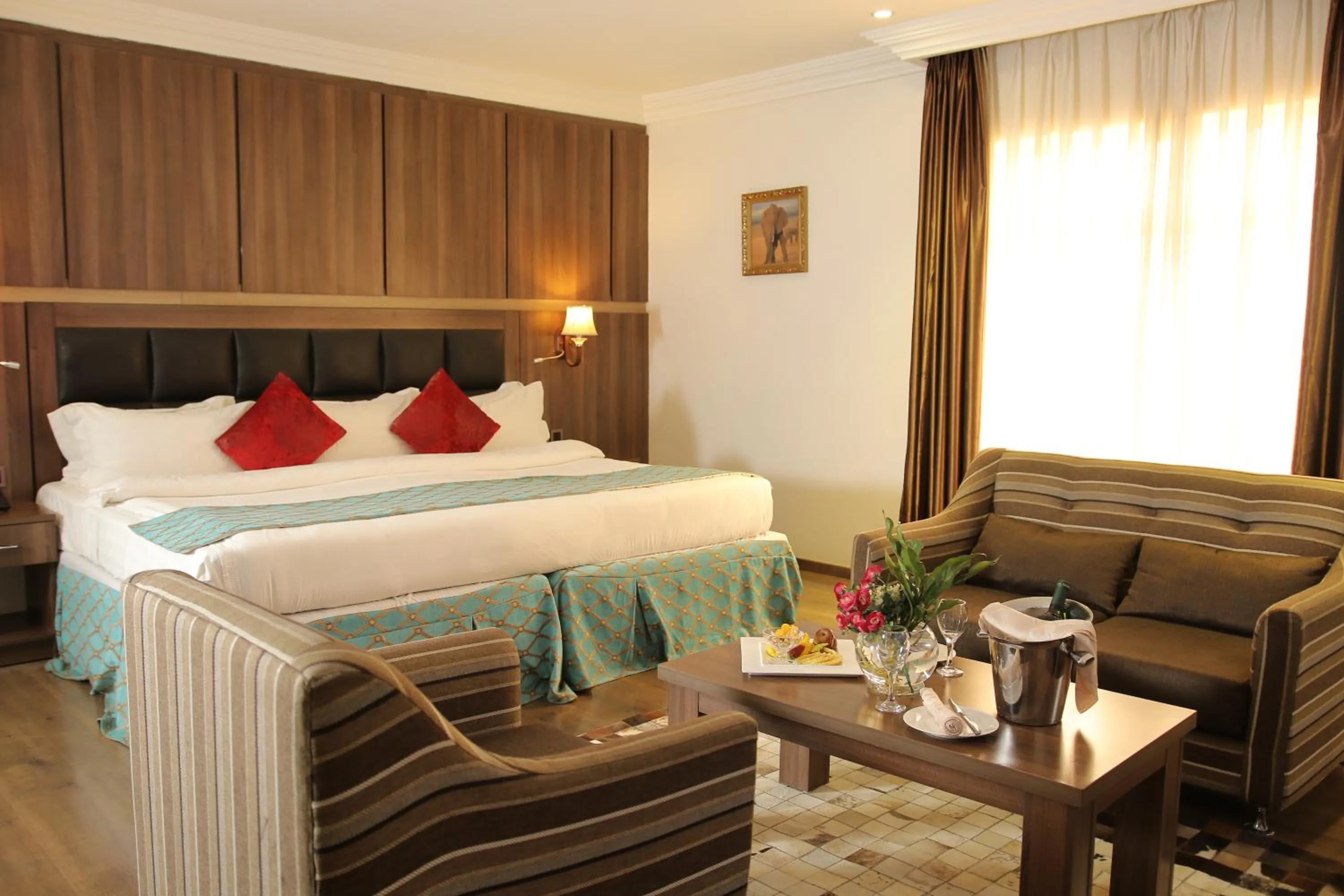 Bed in Grand Pela Hotel & Suites