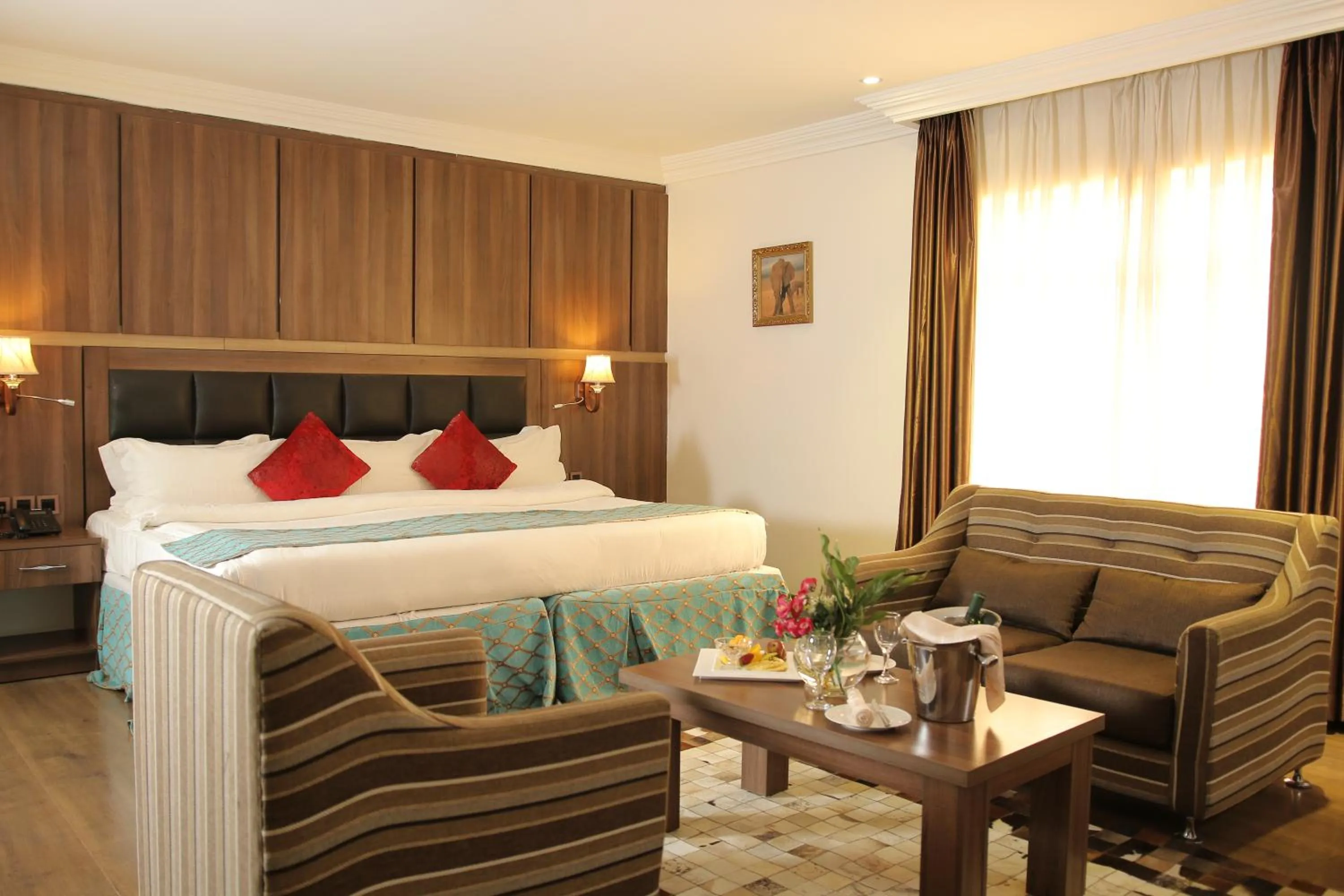 Bed in Grand Pela Hotel & Suites