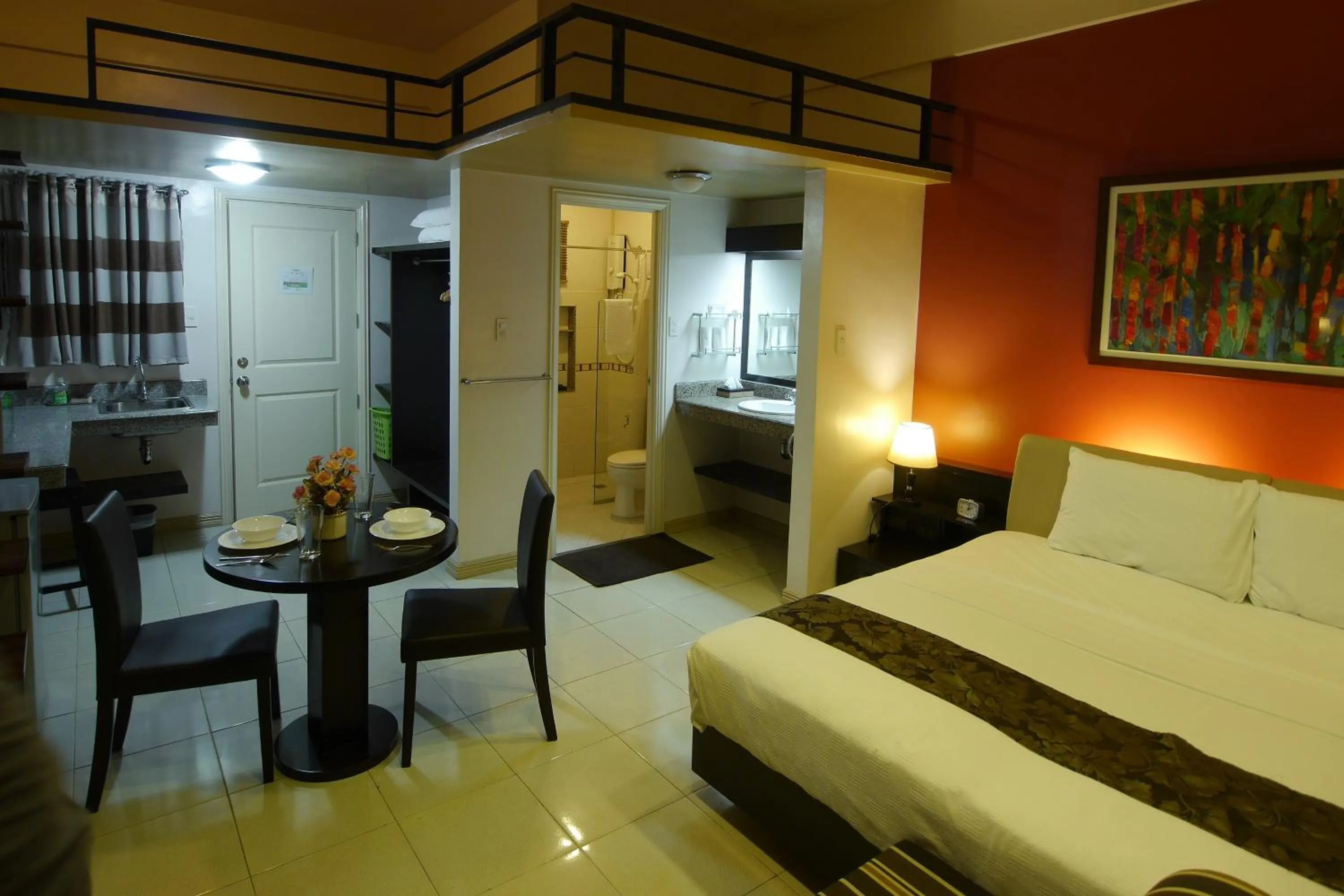 Photo of the whole room, Bed in New Manila Suites