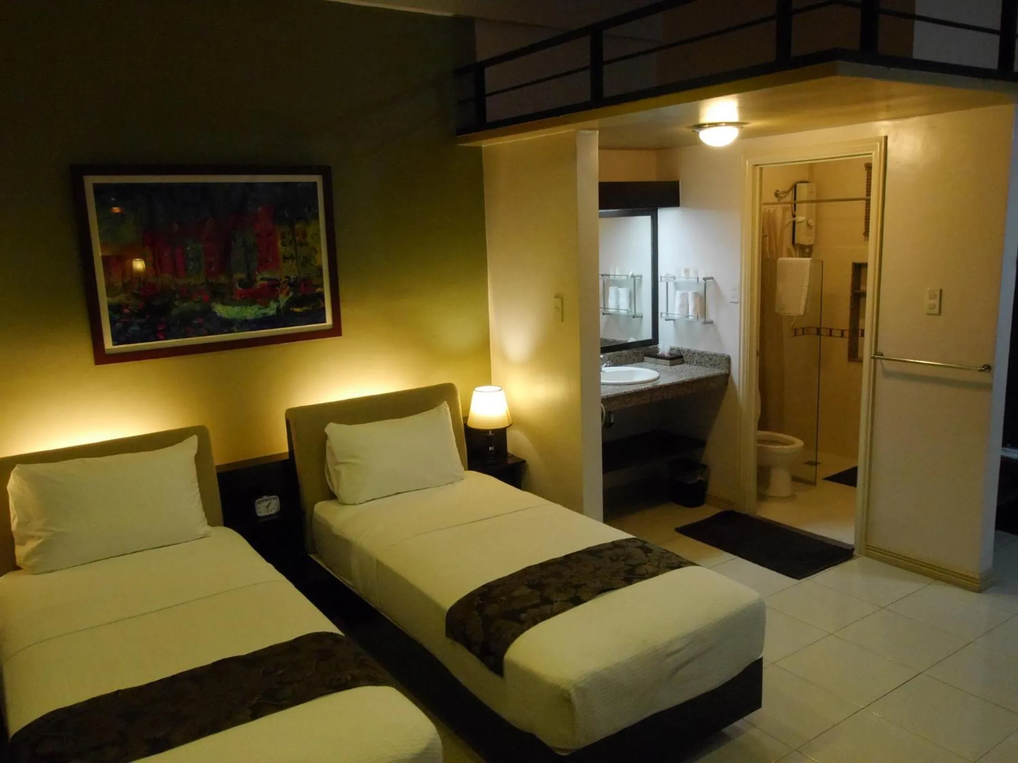 Photo of the whole room, Bed in New Manila Suites