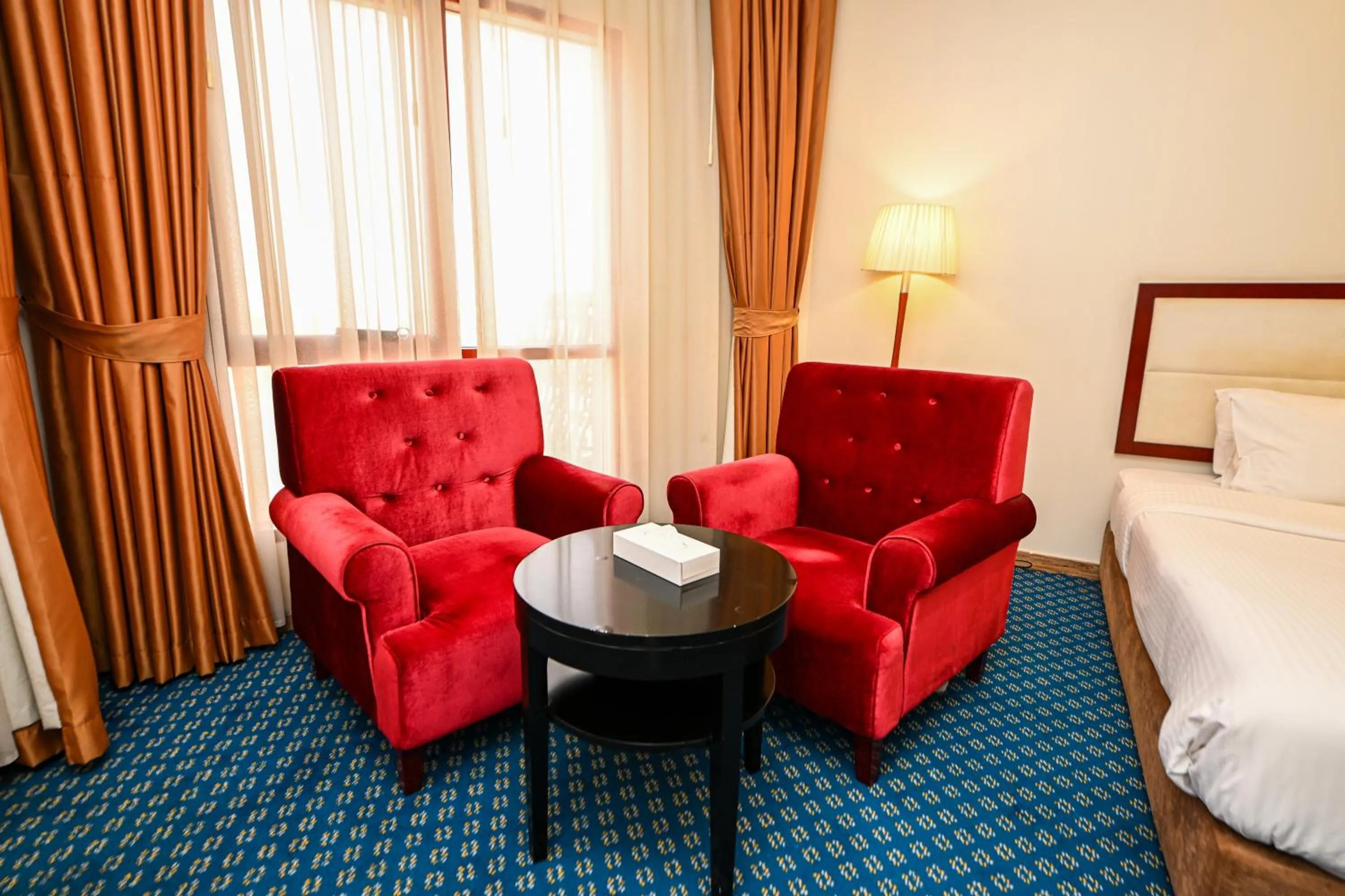 Seating area, Bed in Red Castle Hotel