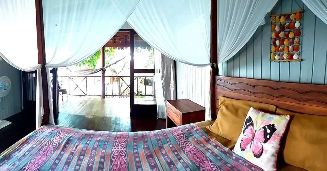 Bed in Nini's Beach Bungalows