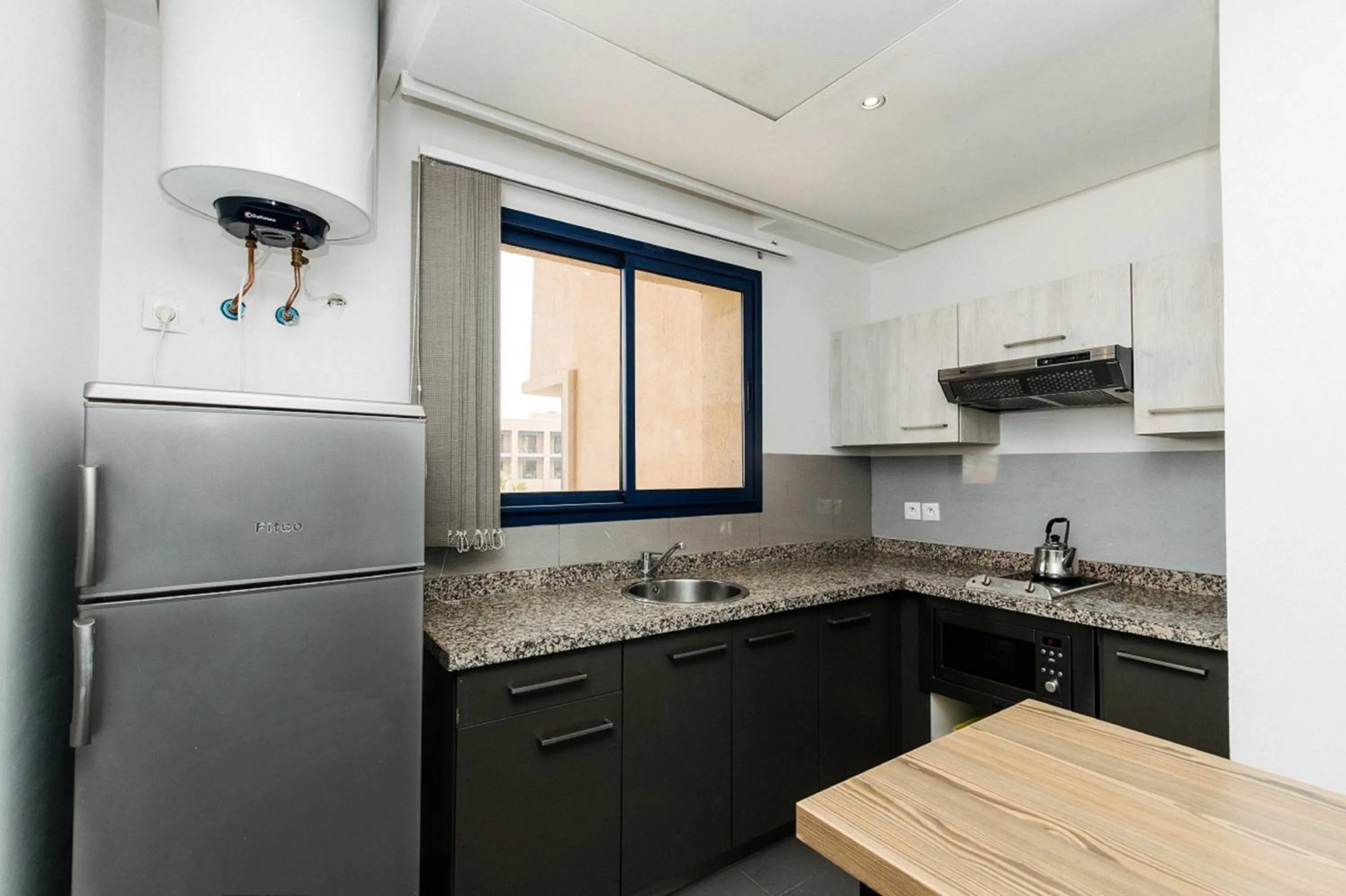 Kitchen or kitchenette in Wazo Appart-Hôtel