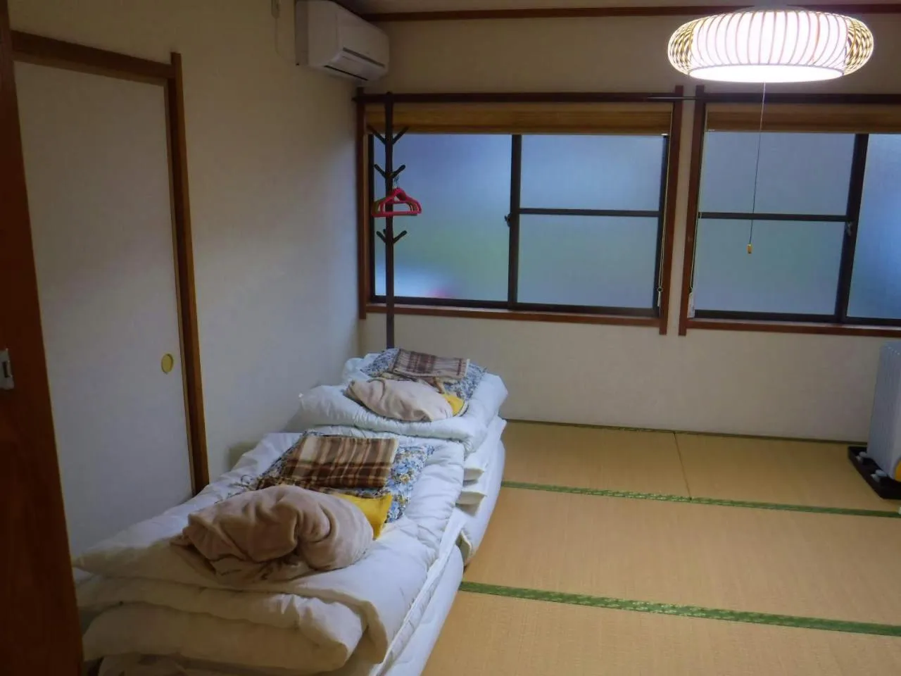 Bed in Wholeearth Ryokan Hiroshima