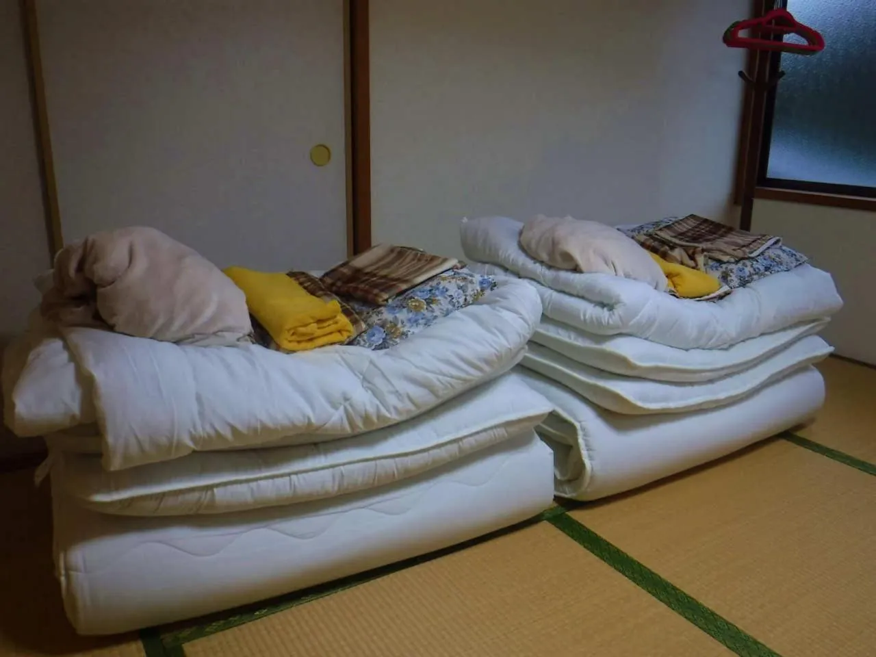 Bed in Wholeearth Ryokan Hiroshima