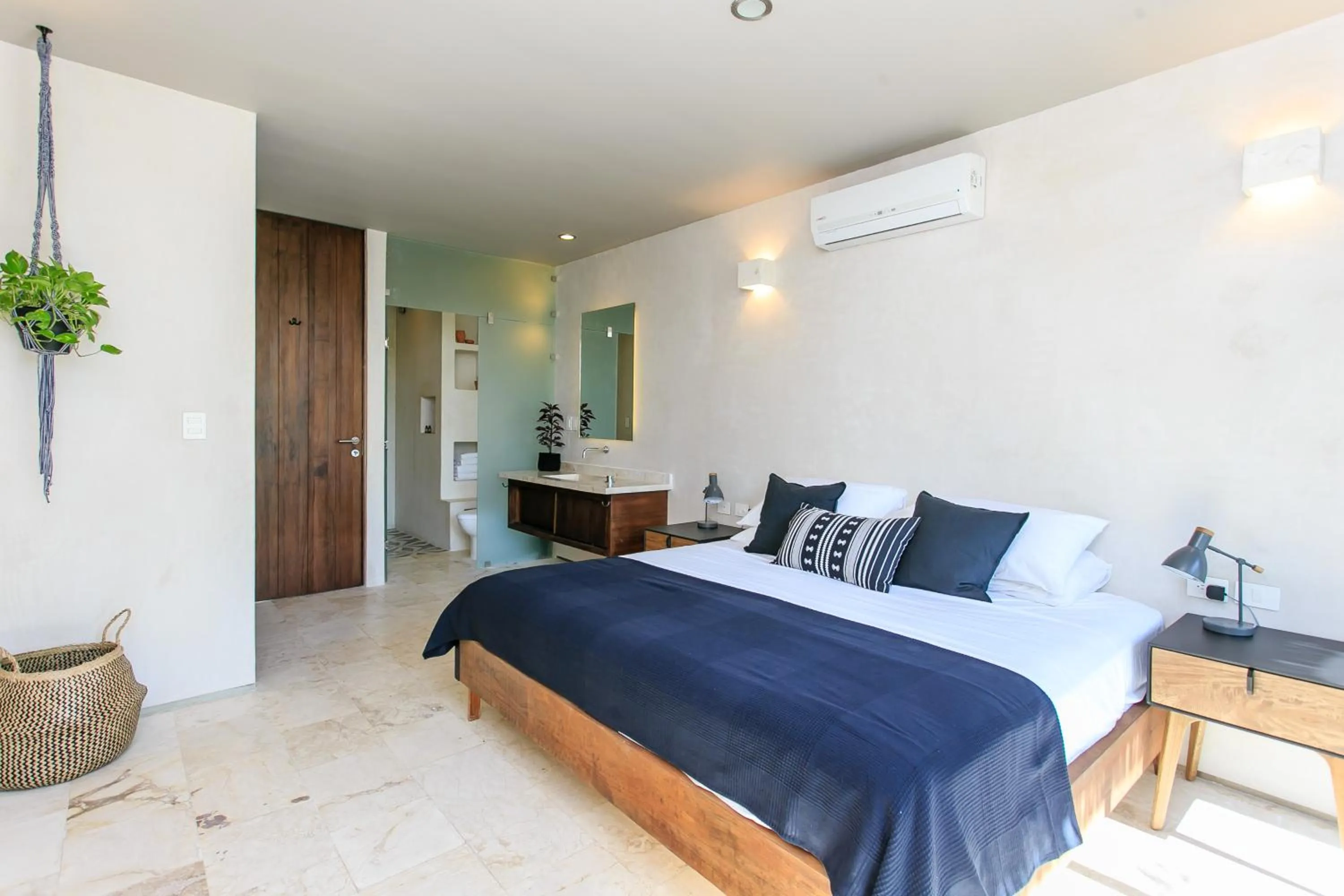 Bedroom, Bed in Eco-chic Design Condos Wrapped in Nature's Elements by Stella Rentals