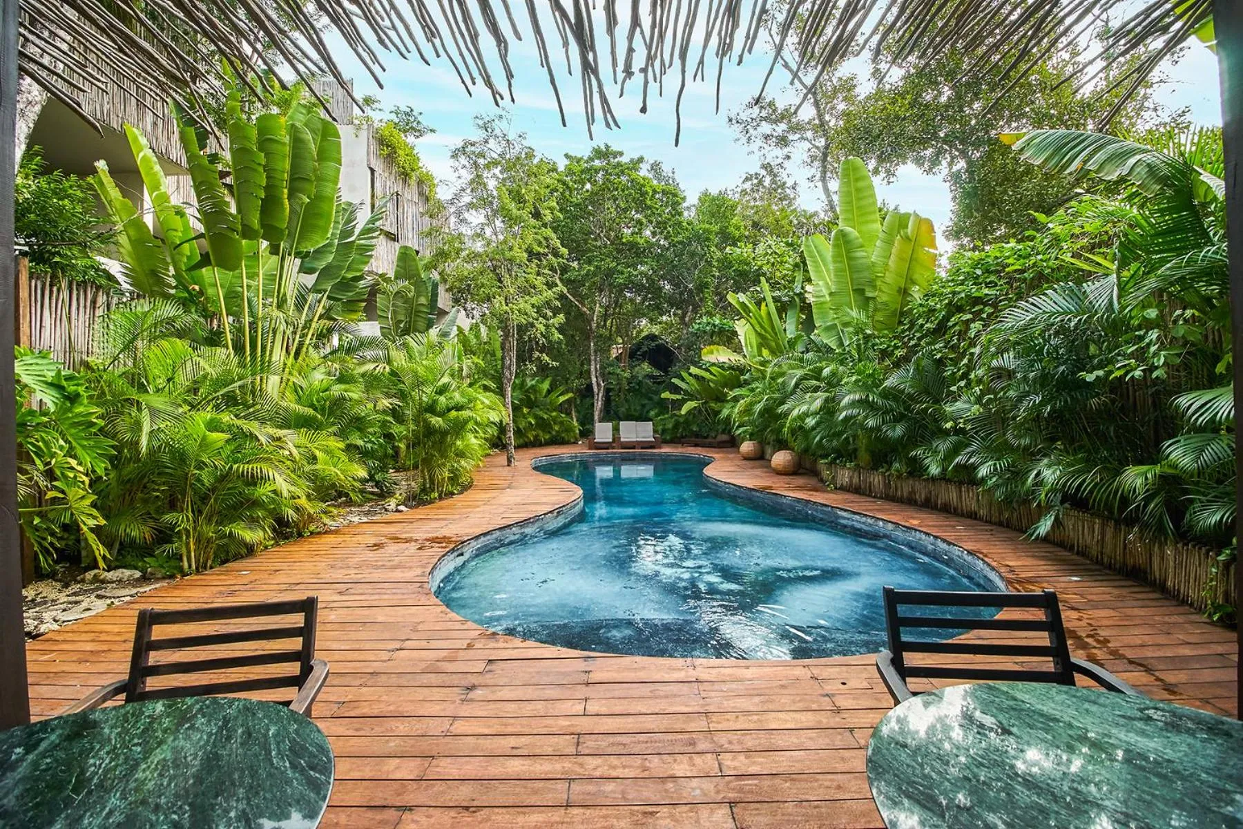 Swimming pool in Eco-chic Design Condos Wrapped in Nature's Elements by Stella Rentals