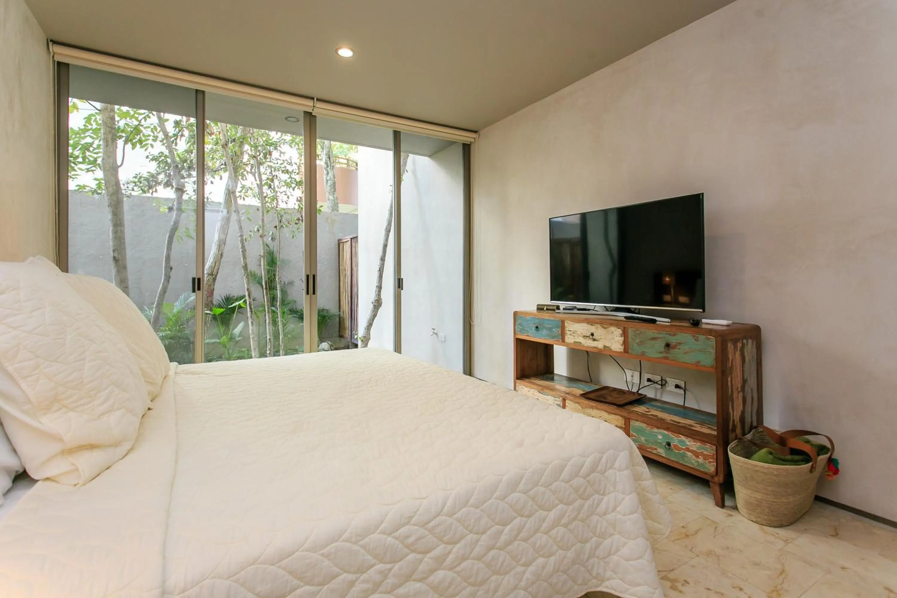 Bedroom, Bed in Eco-chic Design Condos Wrapped in Nature's Elements by Stella Rentals