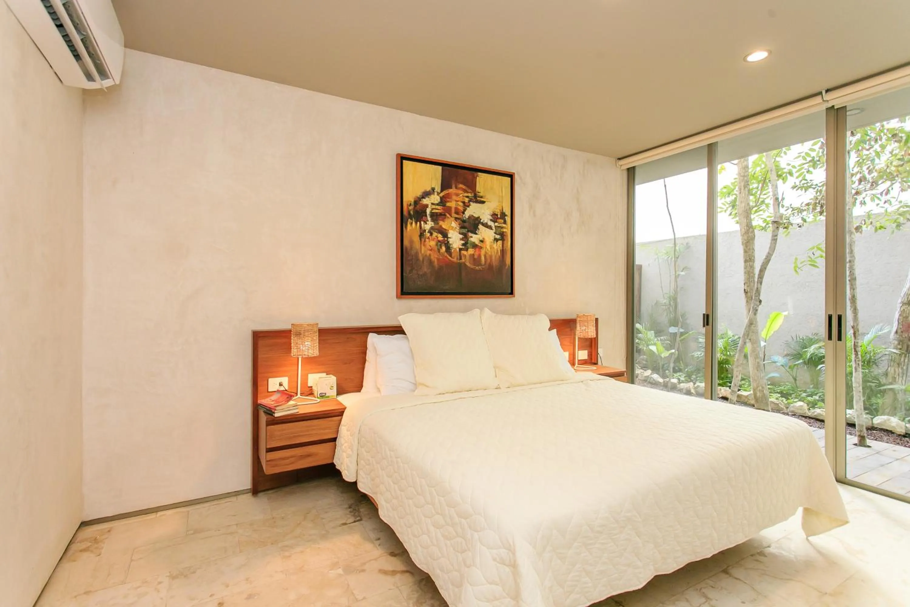 Bedroom, Bed in Eco-chic Design Condos Wrapped in Nature's Elements by Stella Rentals
