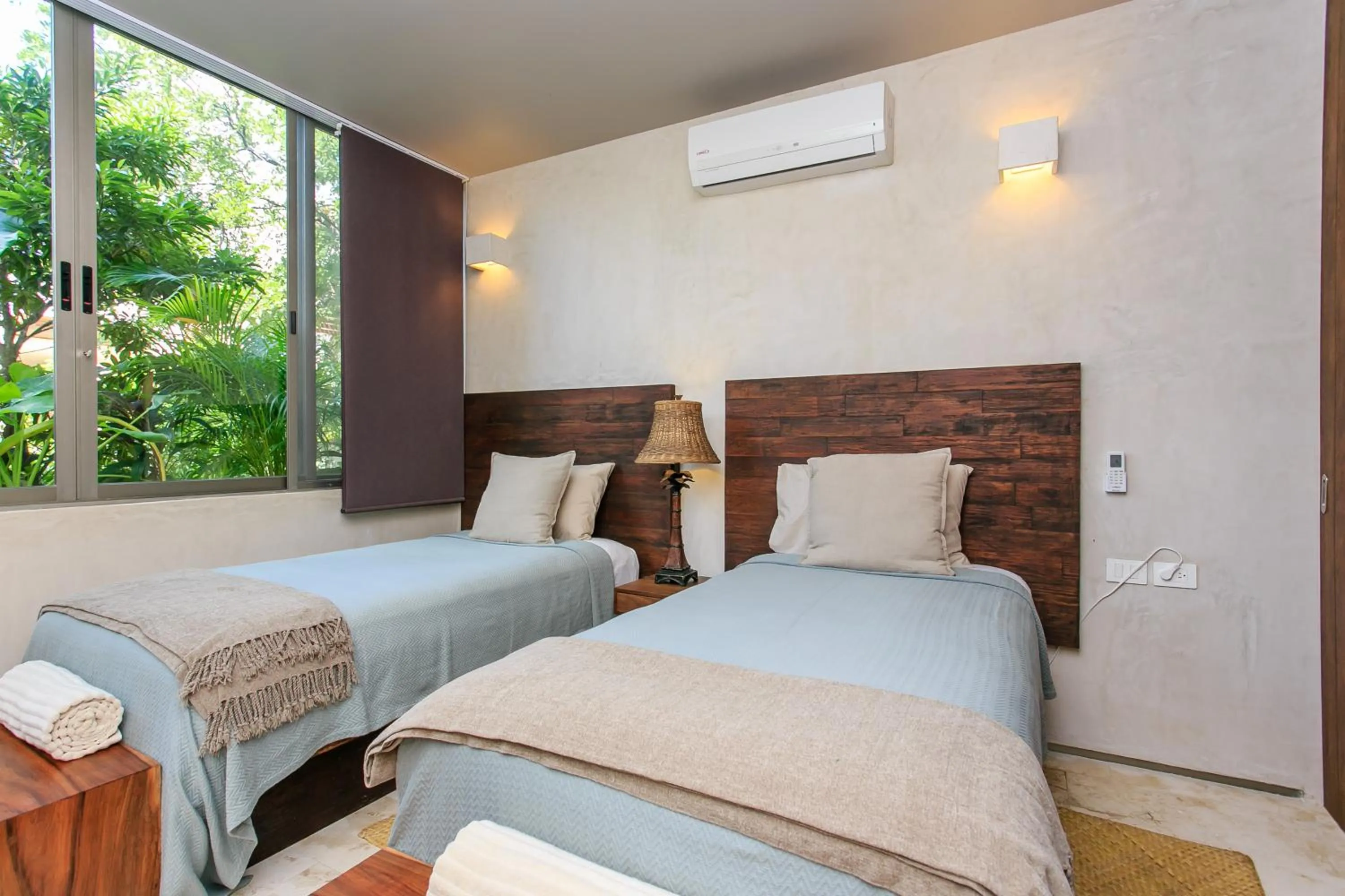 Bedroom, Bed in Eco-chic Design Condos Wrapped in Nature's Elements by Stella Rentals