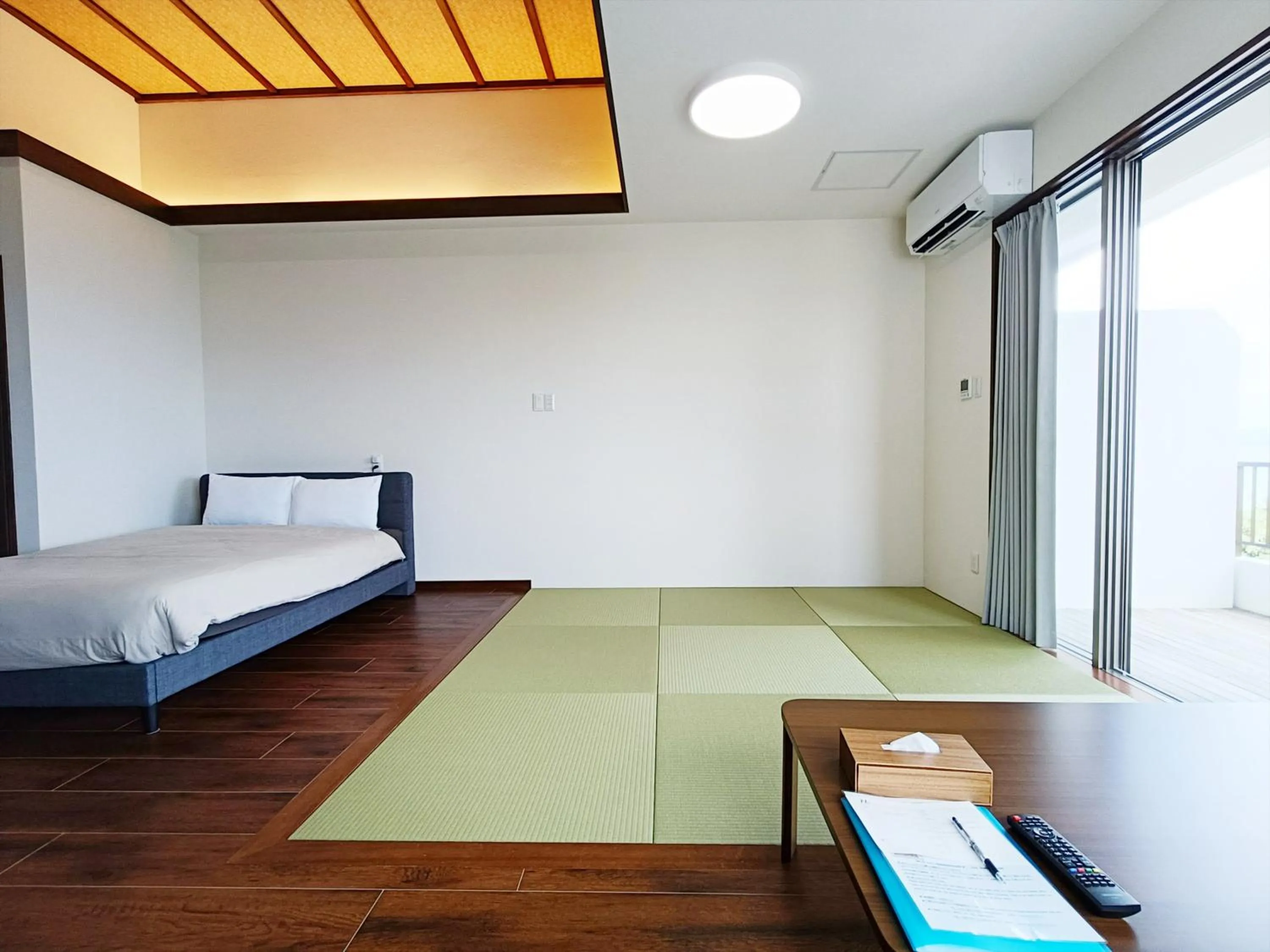Bed in Kariyushi Condominium Resort Sea Side House