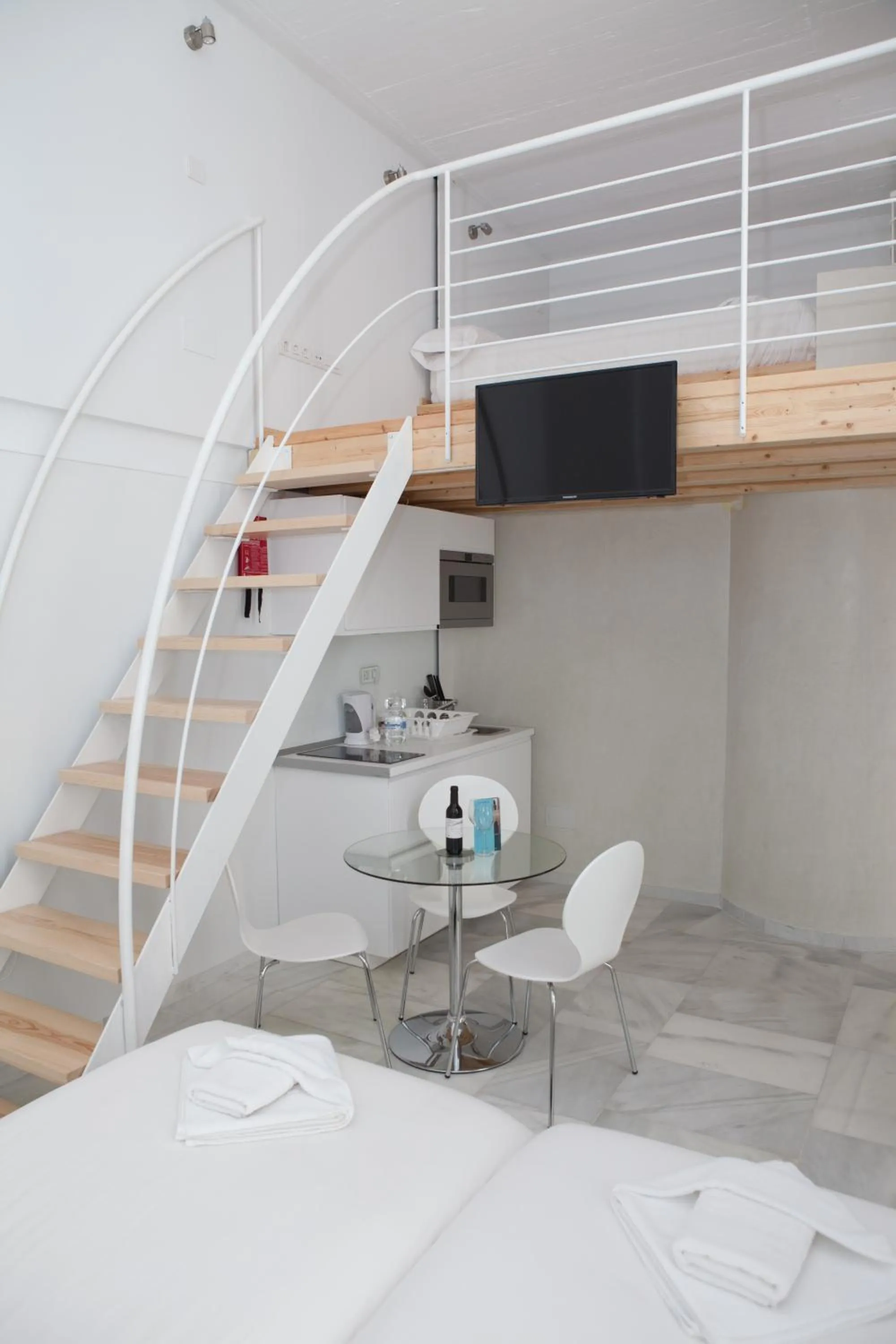 Dining area, Bed in Malaga City Breaks