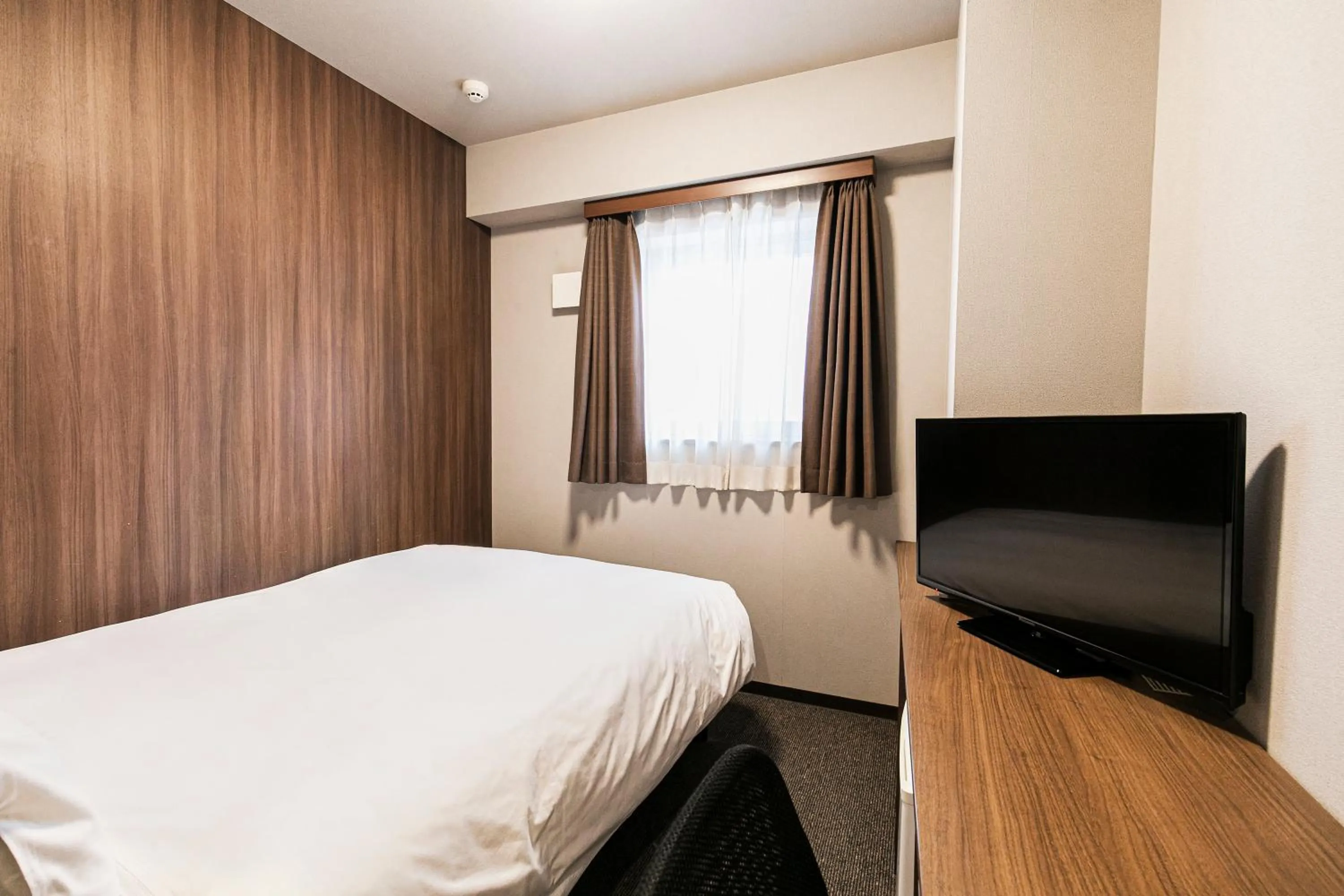 Bed in Smile Hotel Hakataekimae