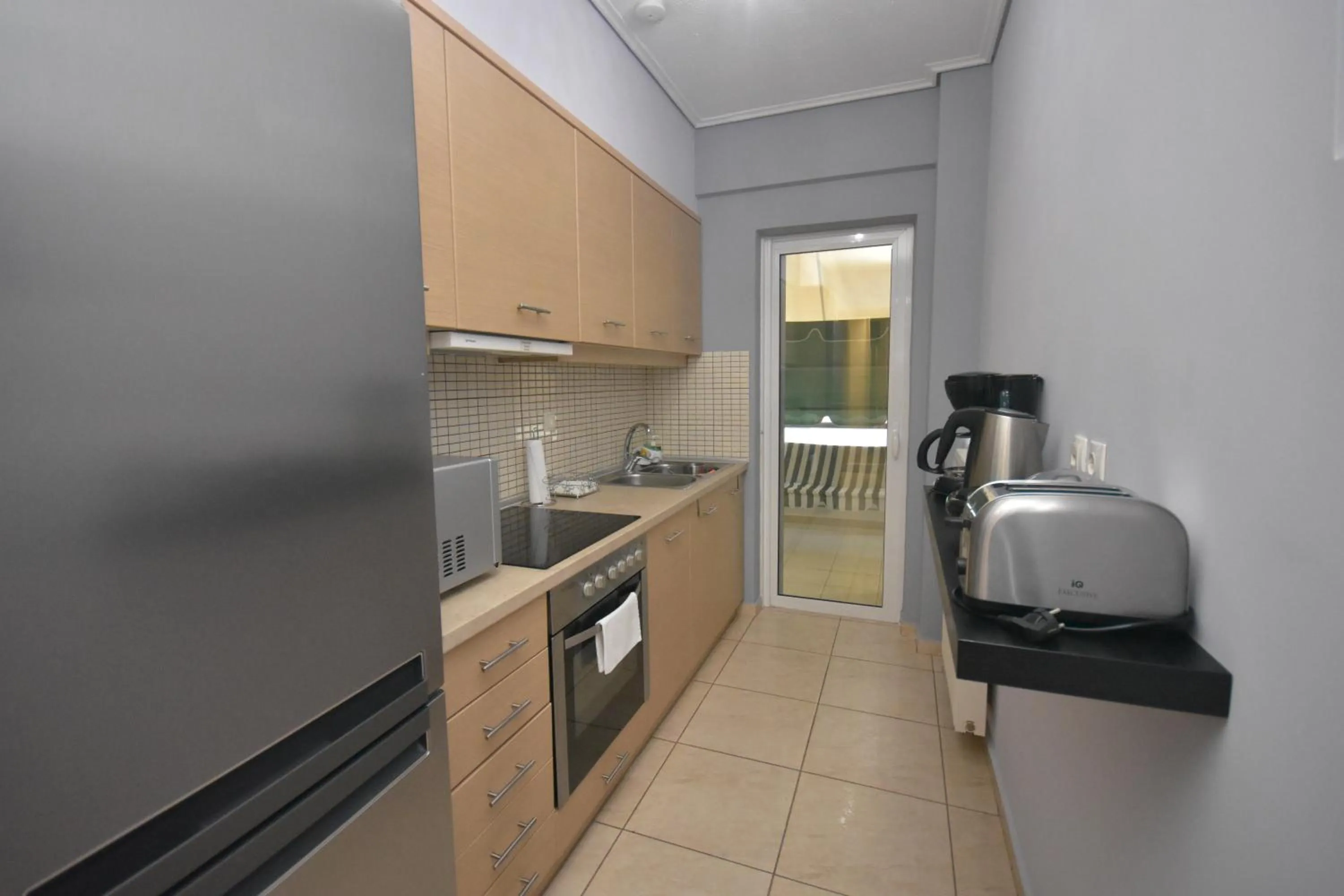 Kitchen or kitchenette in A&J Apartments or Rooms athens airport