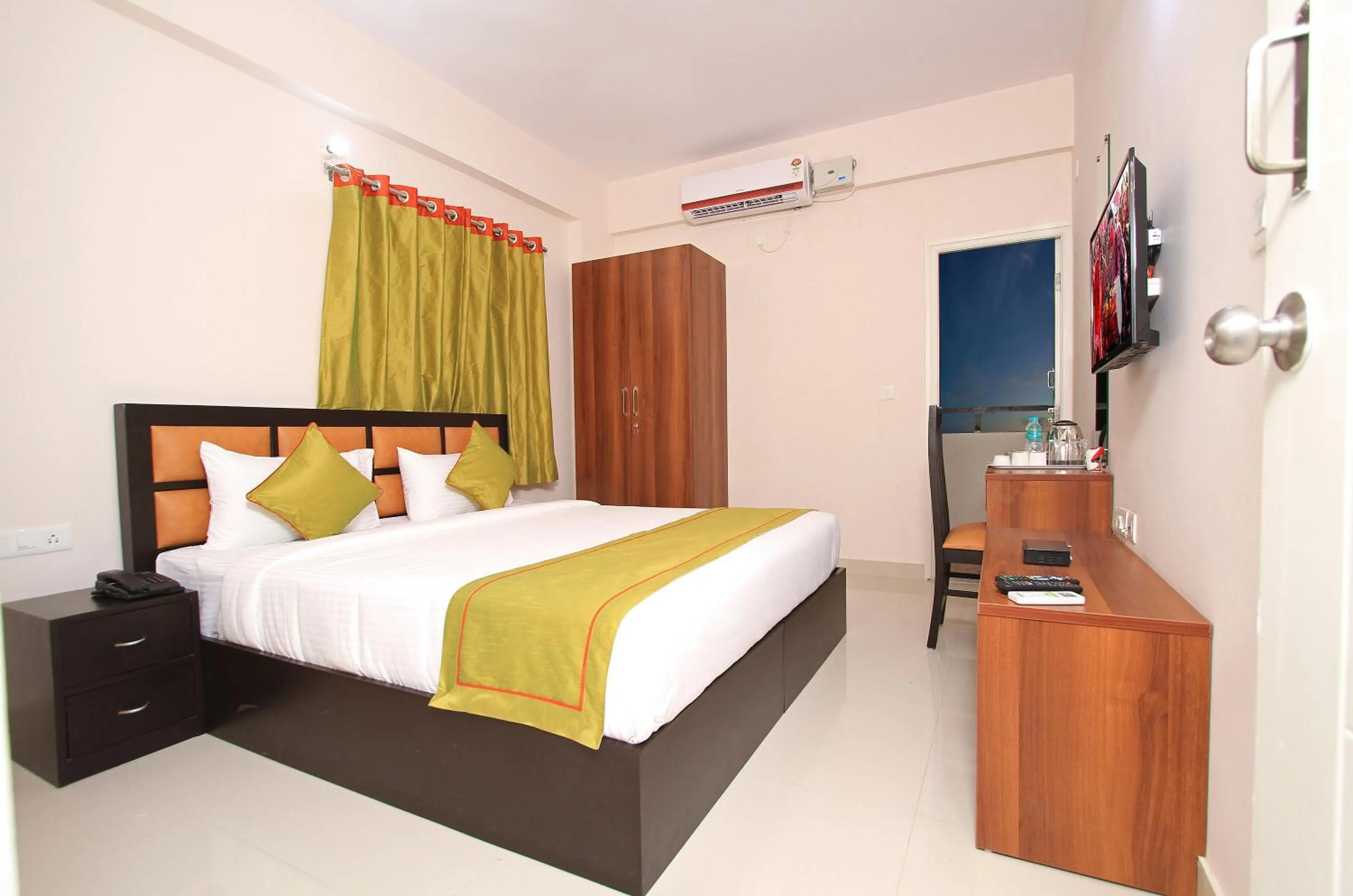 Bed in Arra Grande Suites Bangalore airport hotel