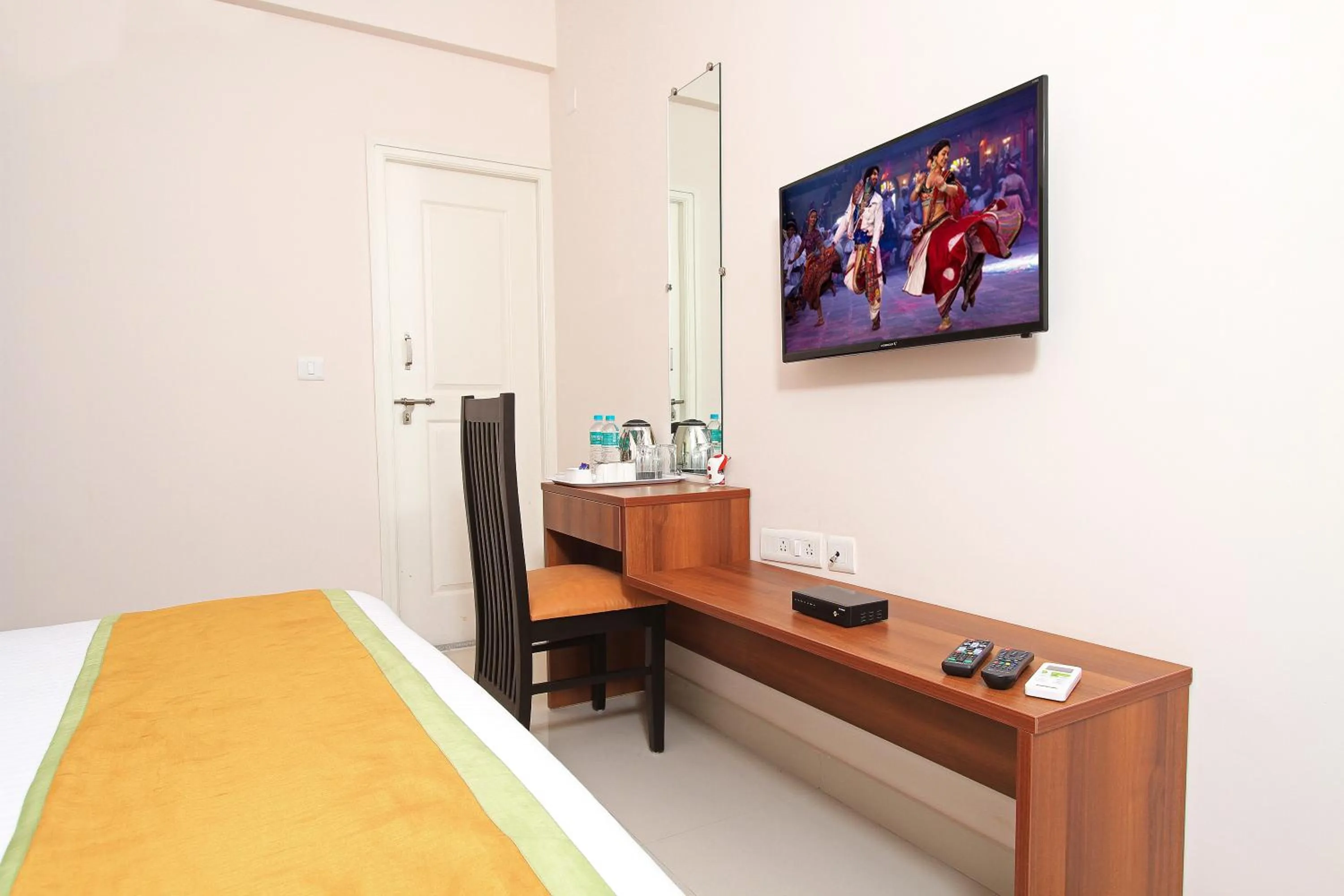 TV and multimedia, Bed in Arra Grande Suites Bangalore airport hotel