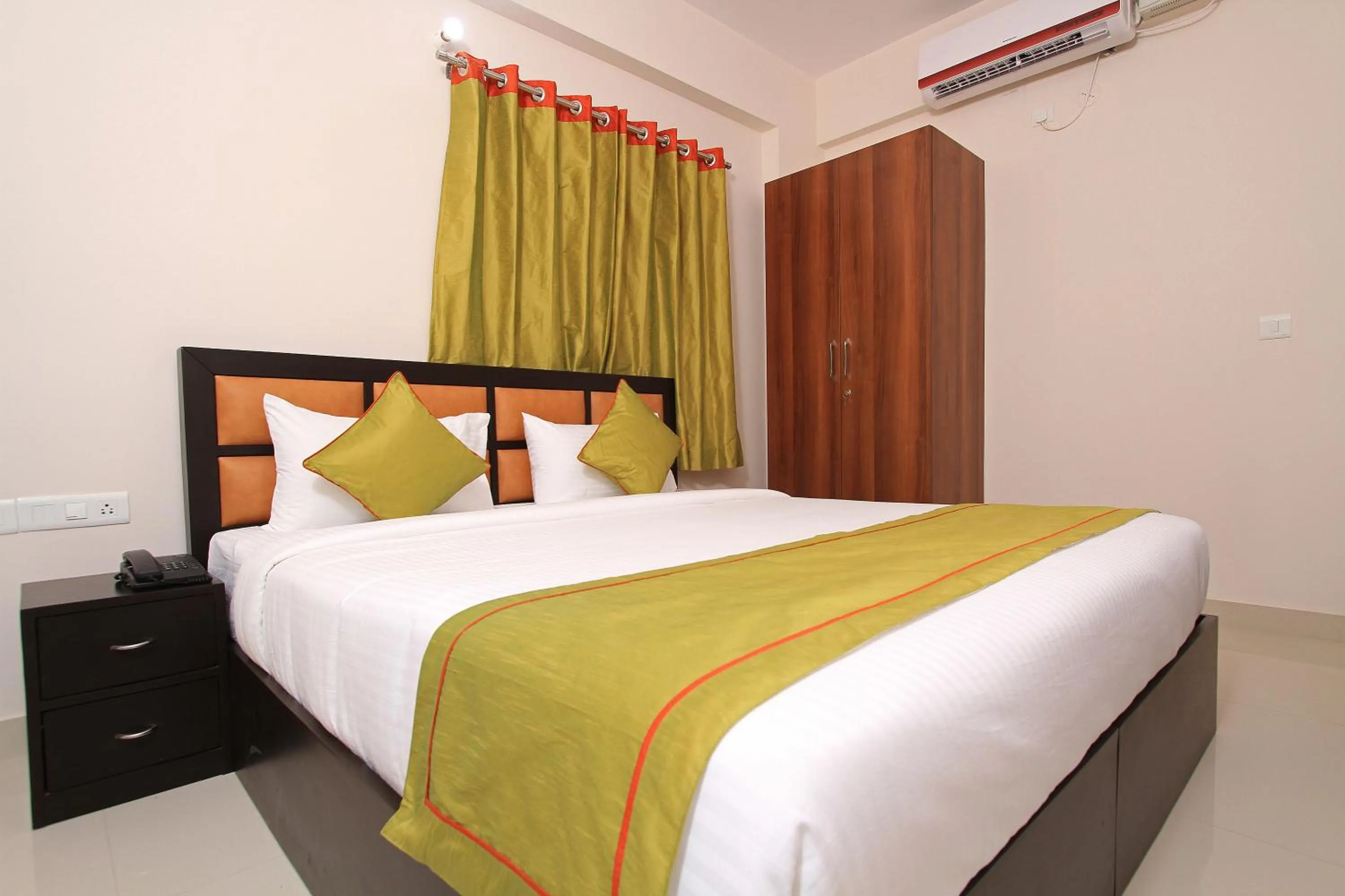 Bed in Arra Grande Suites Bangalore airport hotel