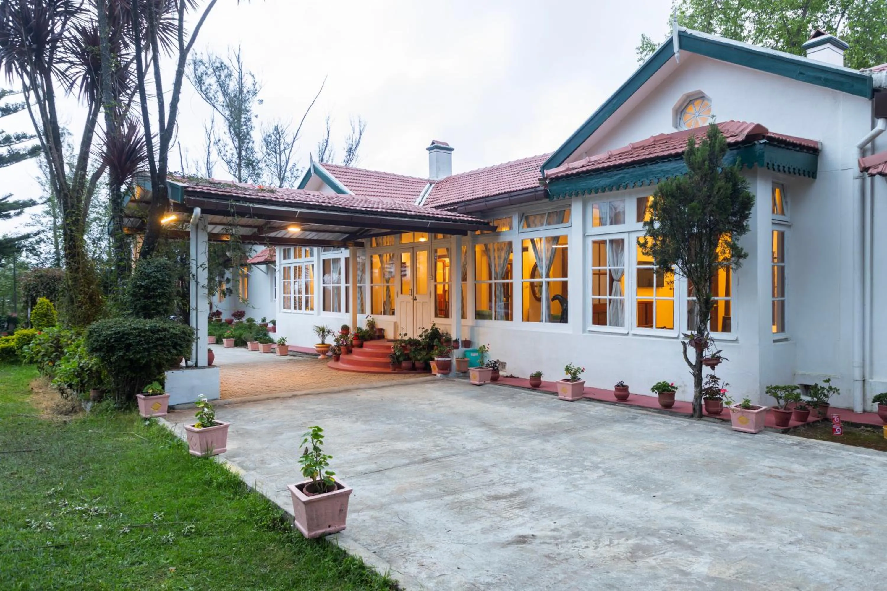 Property building in SaffronStays Milton Abbott Estate - 2BR colonial-era bungalow with garden, golf course views & bonfire nights near Ooty Golf Club