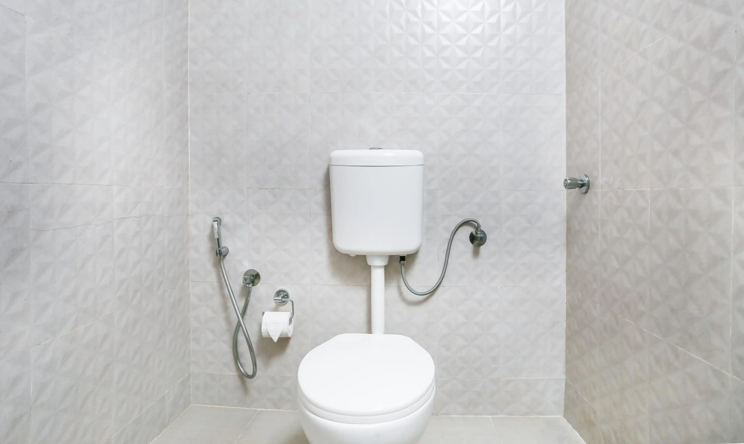 Bathroom in Treebo Comforts Inn, University Road Deralakatte