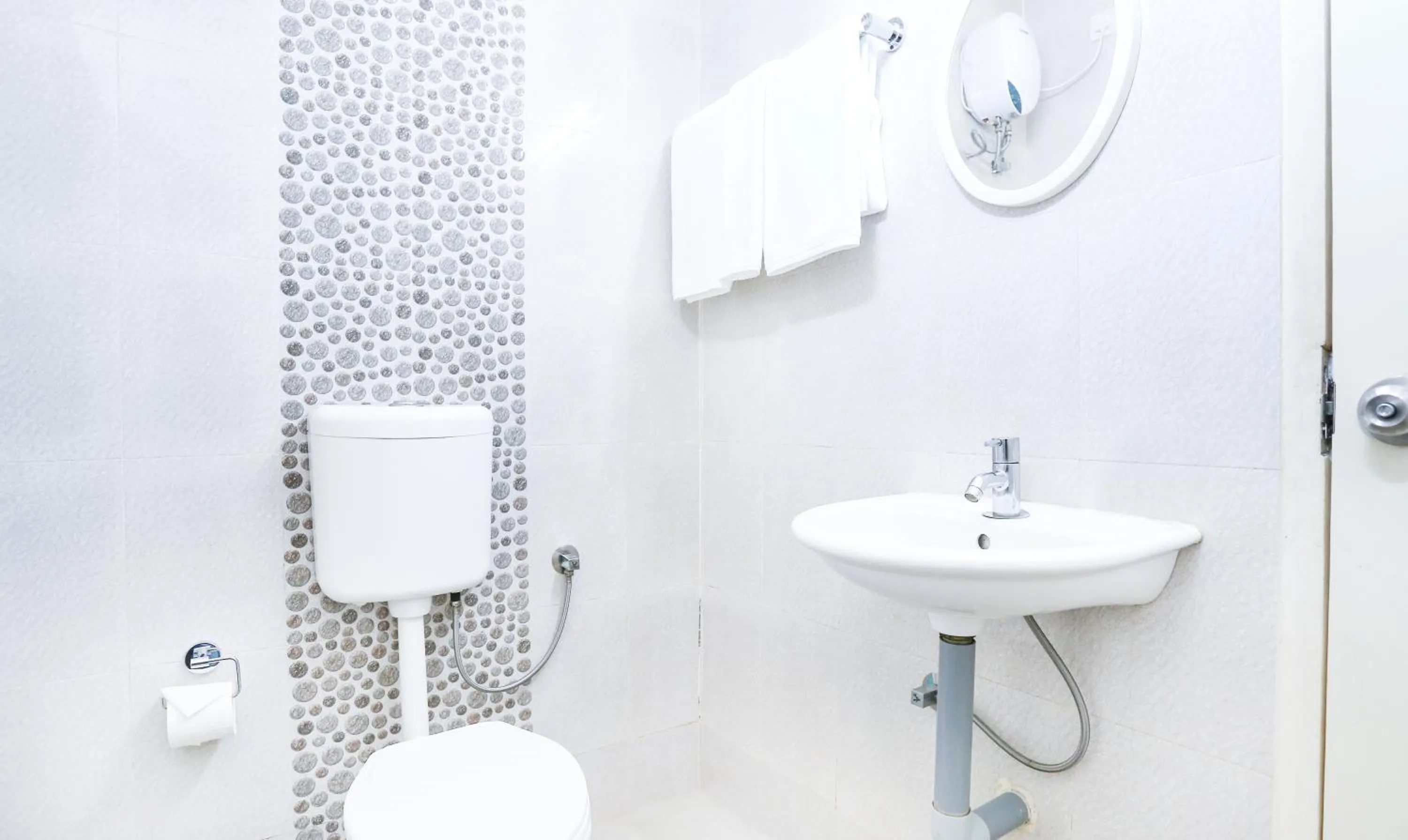 Bathroom in Treebo Comforts Inn, University Road Deralakatte