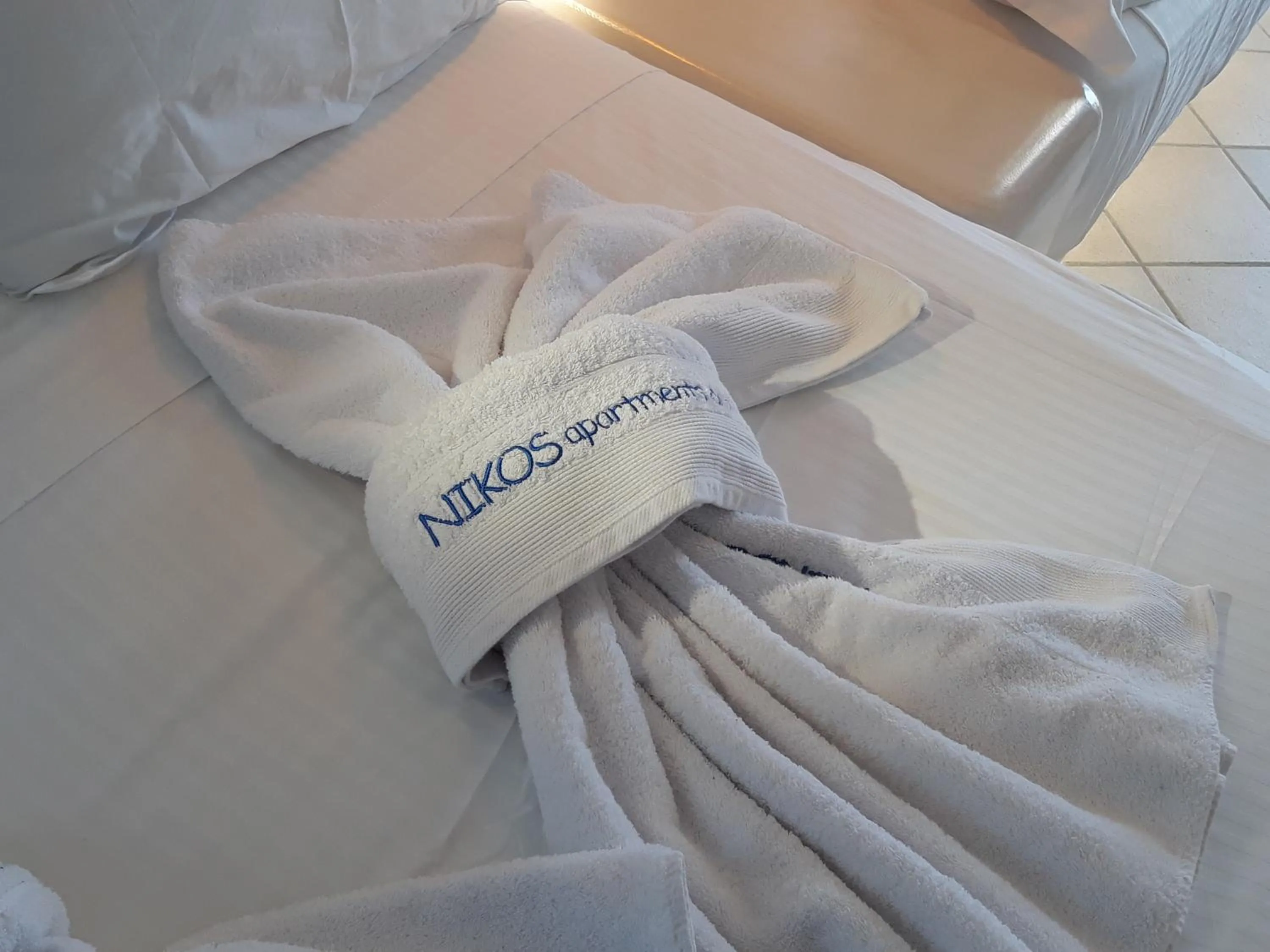 towels, Bed in Nikos Apartments and Studios