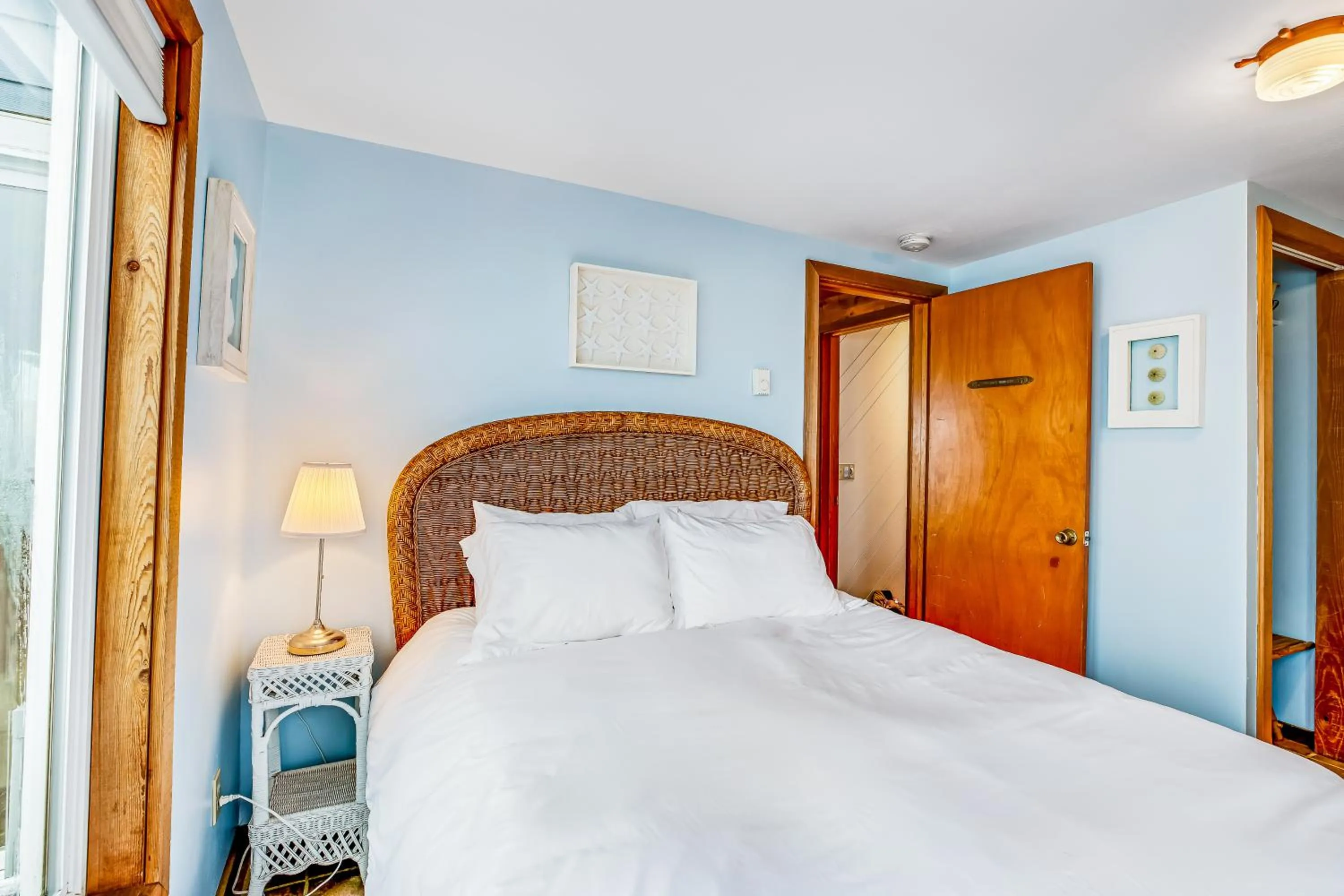 Bed in Blue Sea Oceanfront Cottage