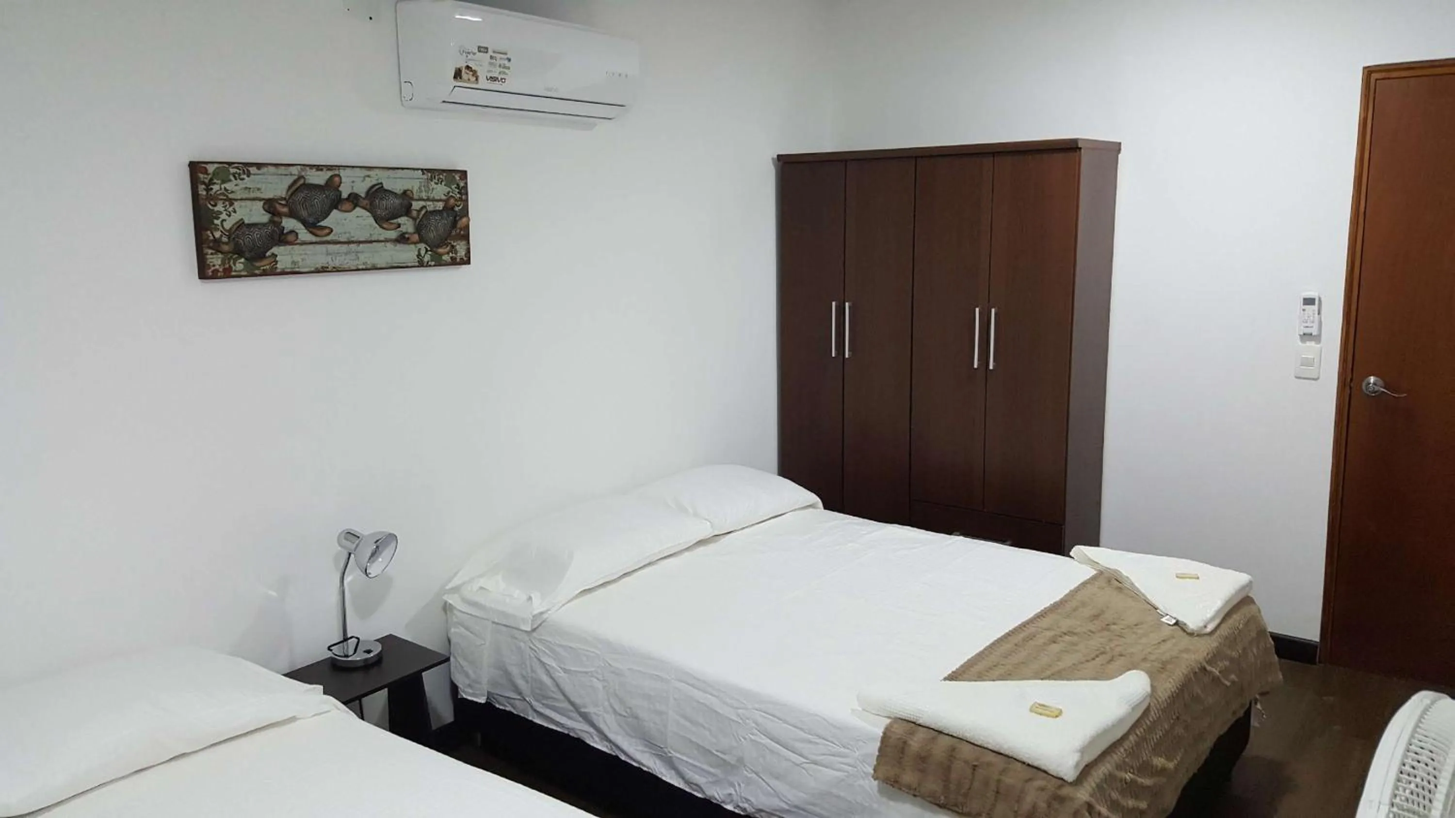 Bed in Beach Paradise Apartments