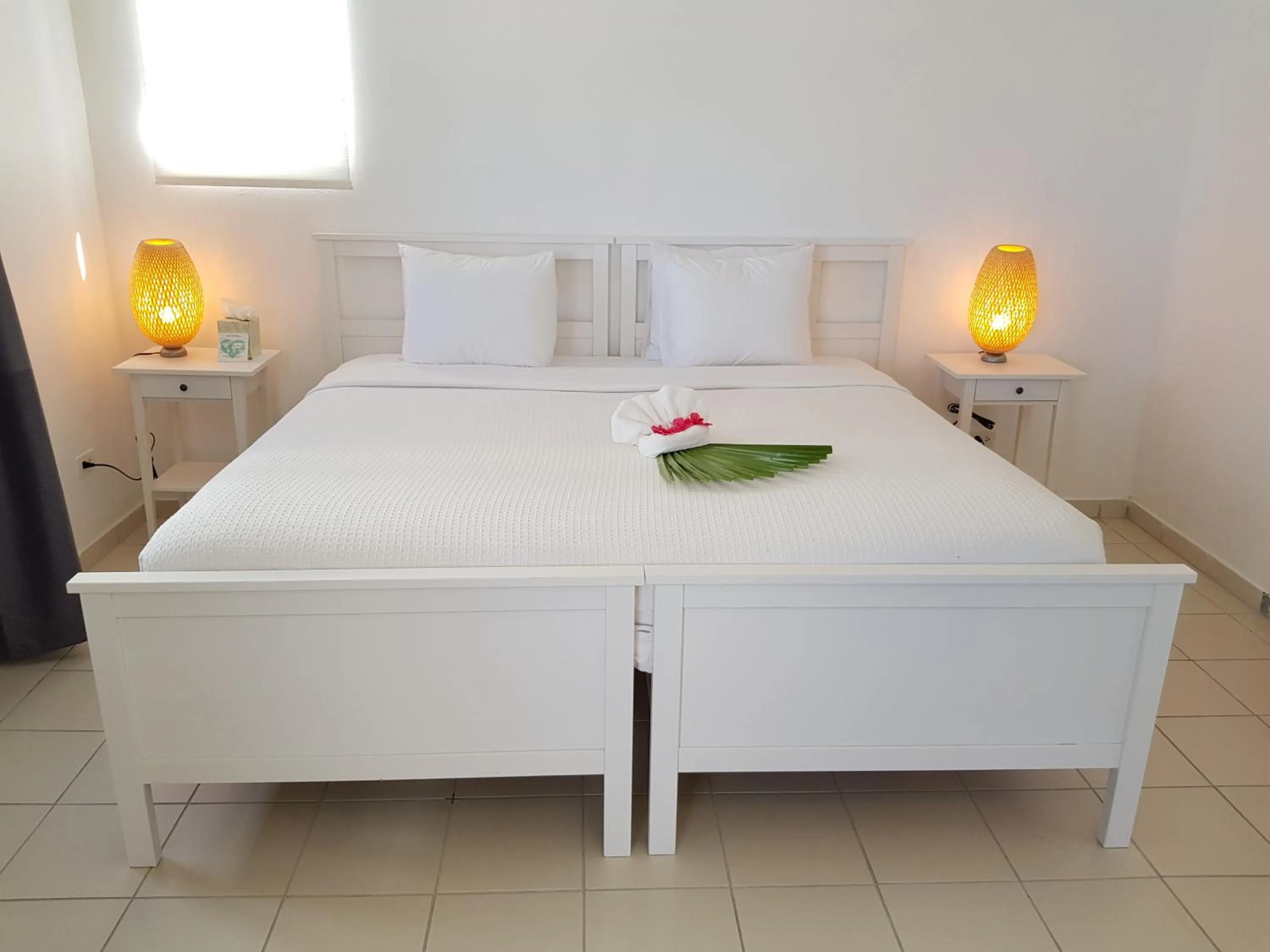 Bed in Turtle's Nest Beach Resort