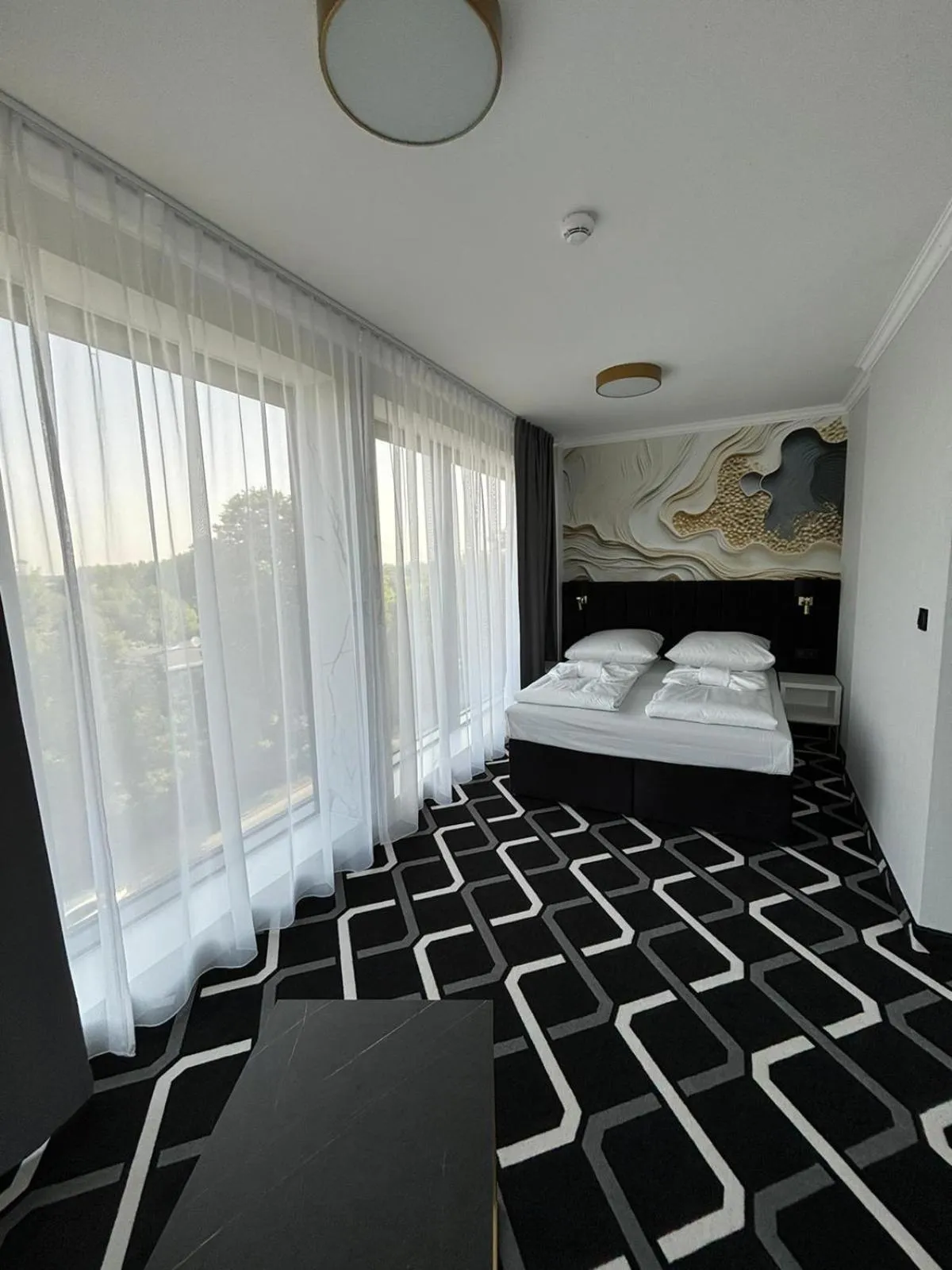 Bed in Hotel Lantier & Swimming Pool Zone