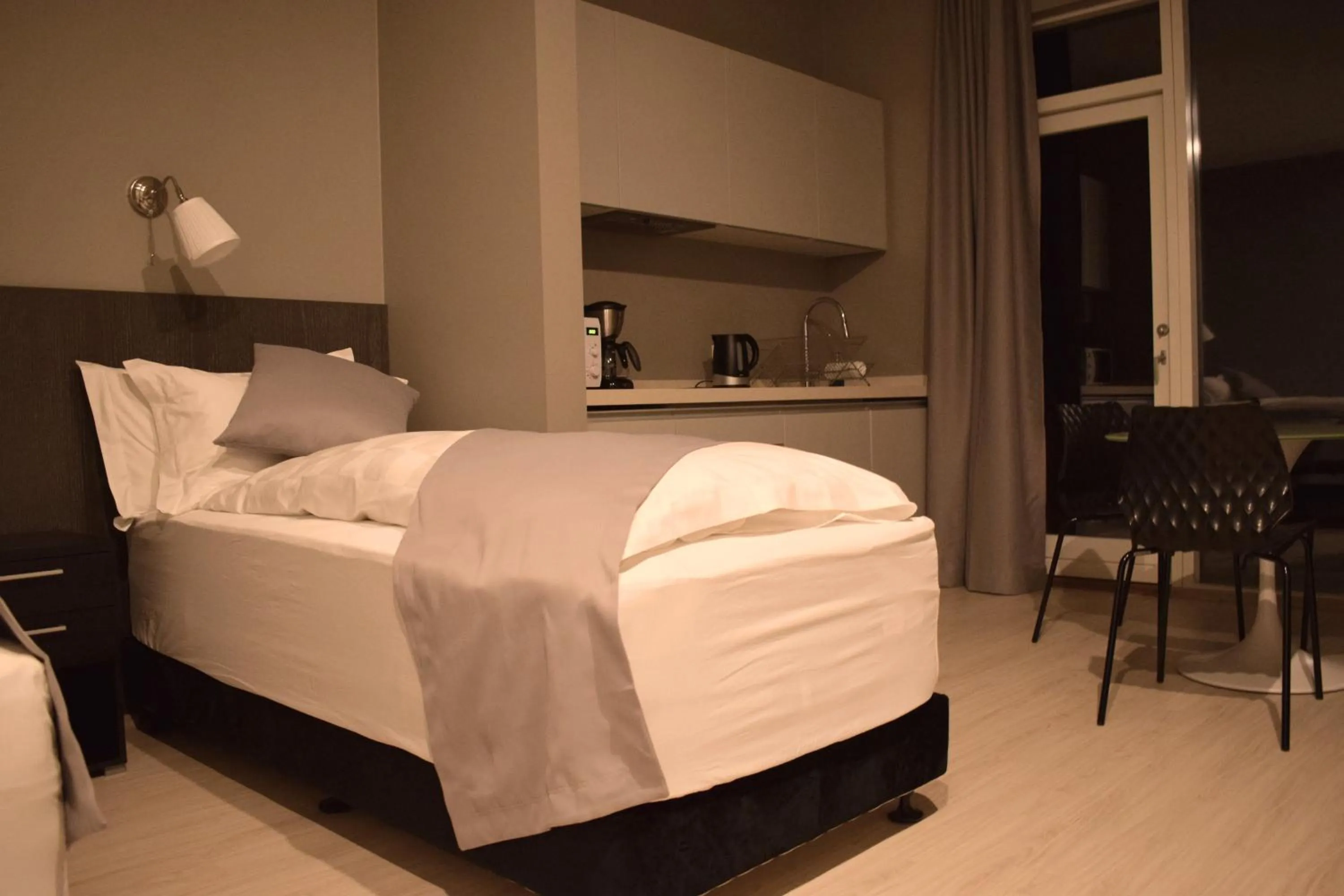 Bed in Black Beach Suites