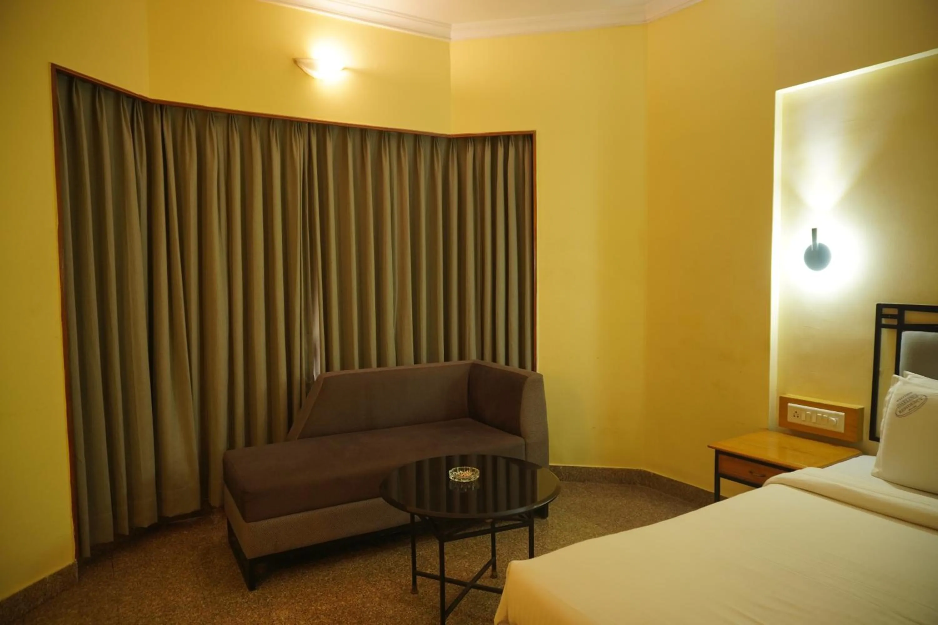 Seating area, Bed in Darling Residency