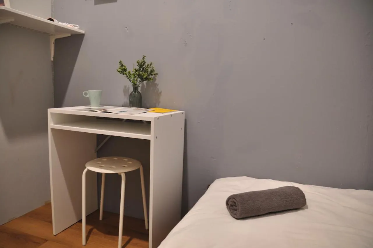 Bed in GRAYHAUS Guest House