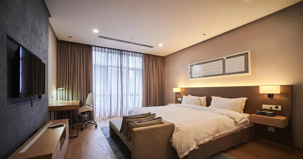 Bed in 188 Suites by NamaStay