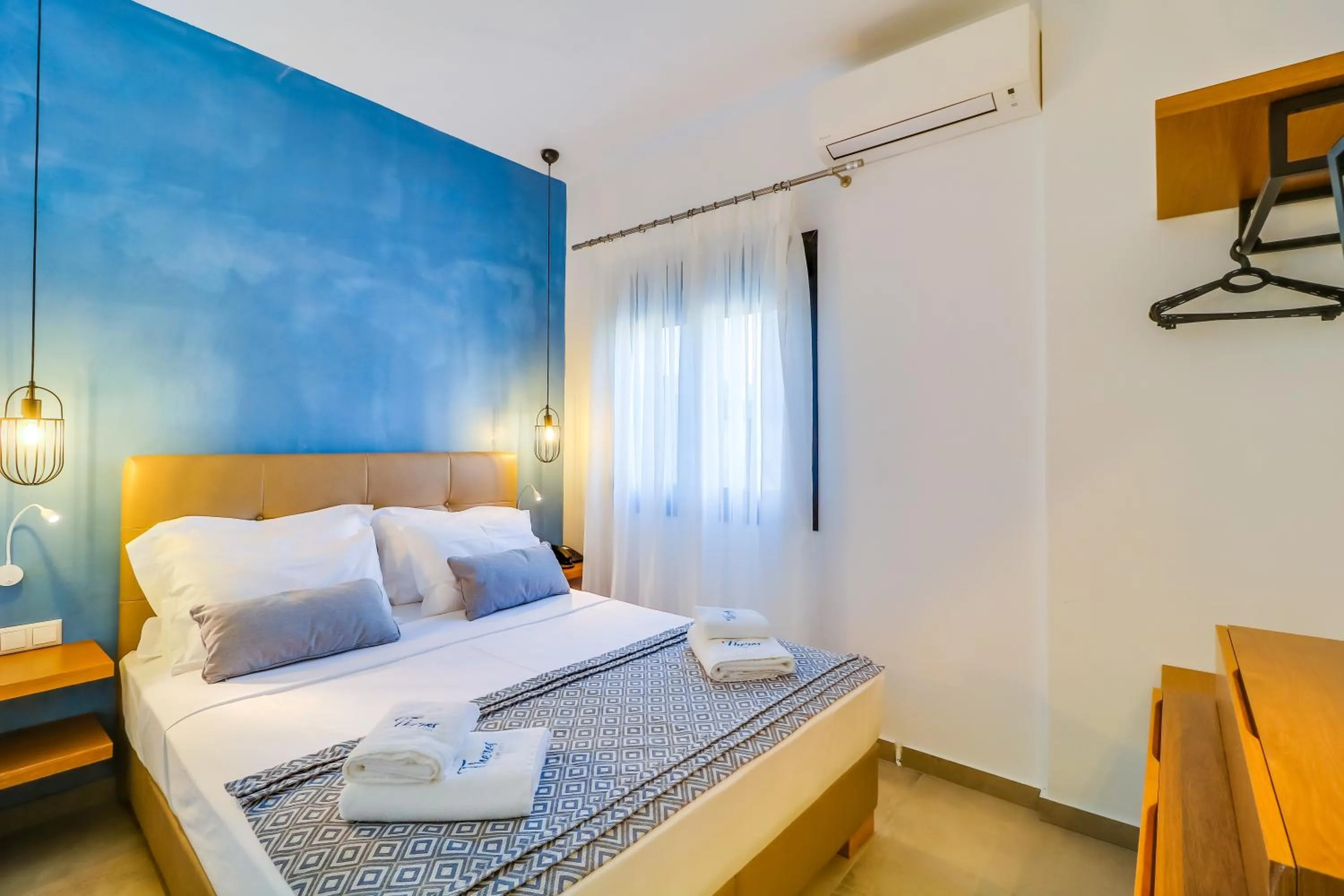 Bed in Theros Villas & Suites